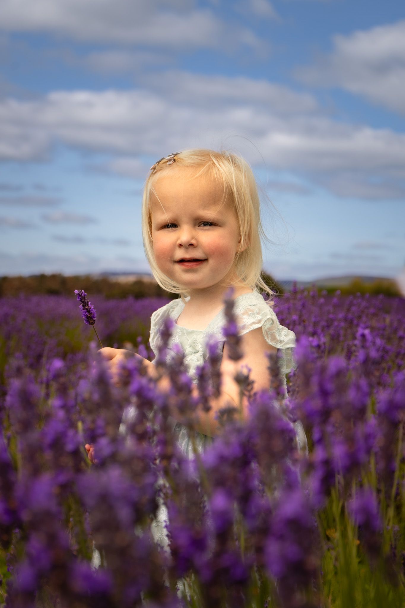 young girl smiling amongst the lavender at Scotland's Lavender Oils in Kinross,
