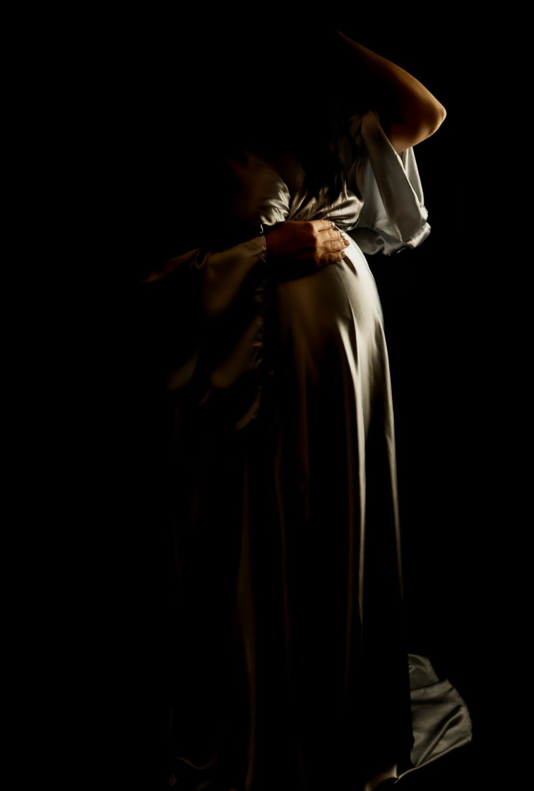 Studio maternity photoshoot showing pregnant woman in professional home studio setting