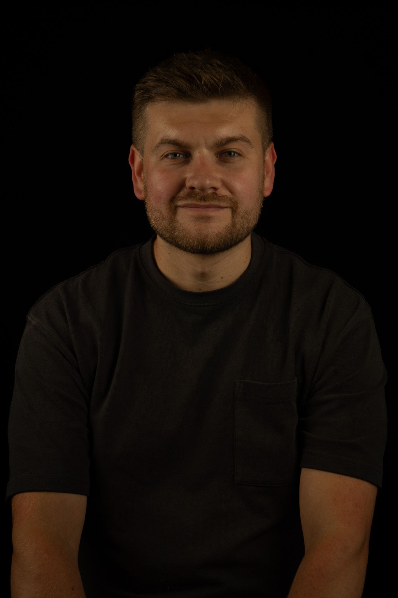 Cropped headshot of male taken against a black background, North Lanarkshire.