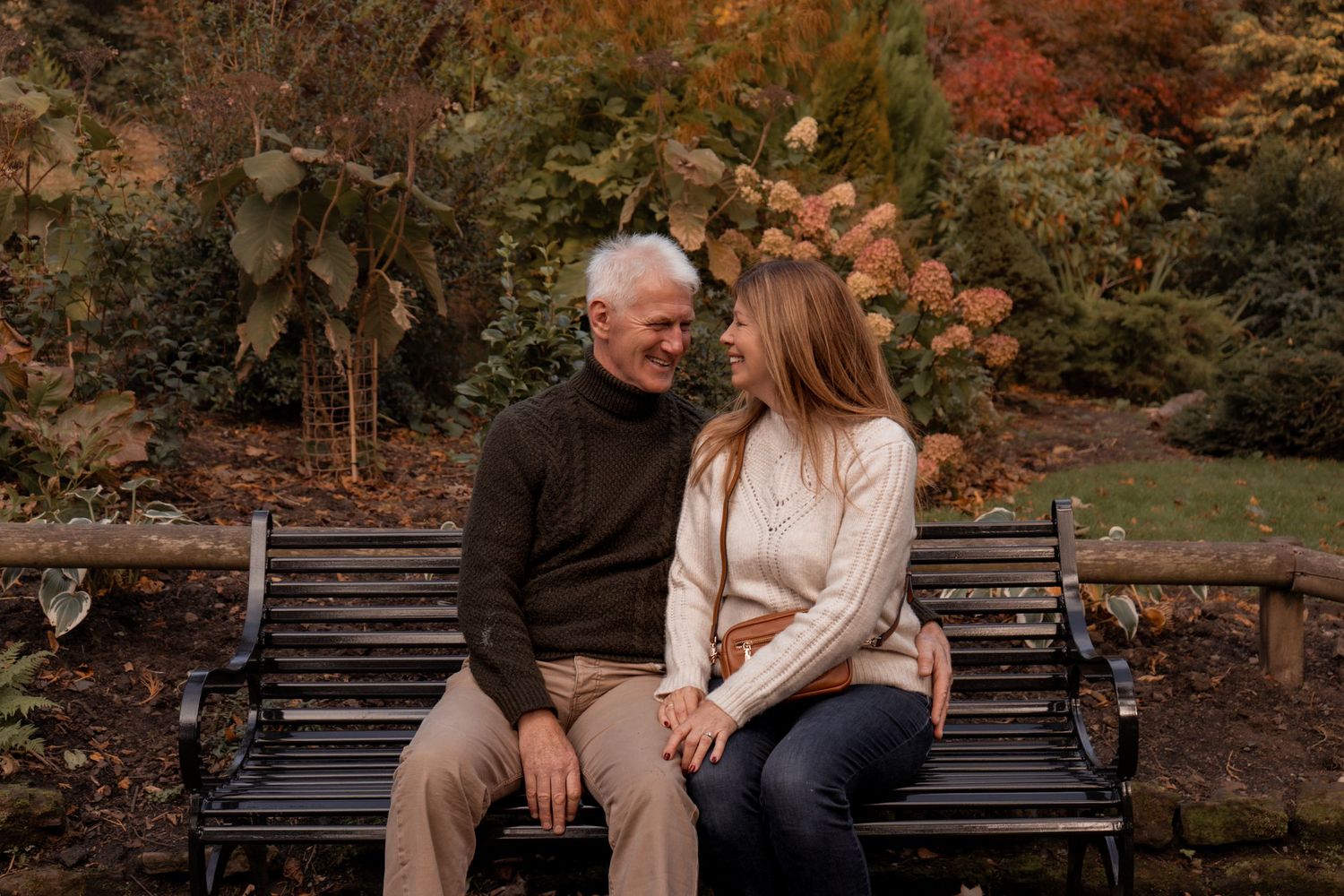 Grandparents photographed smiling at each other mid photo-shoot at Pittencrief Park in Dunfermline.