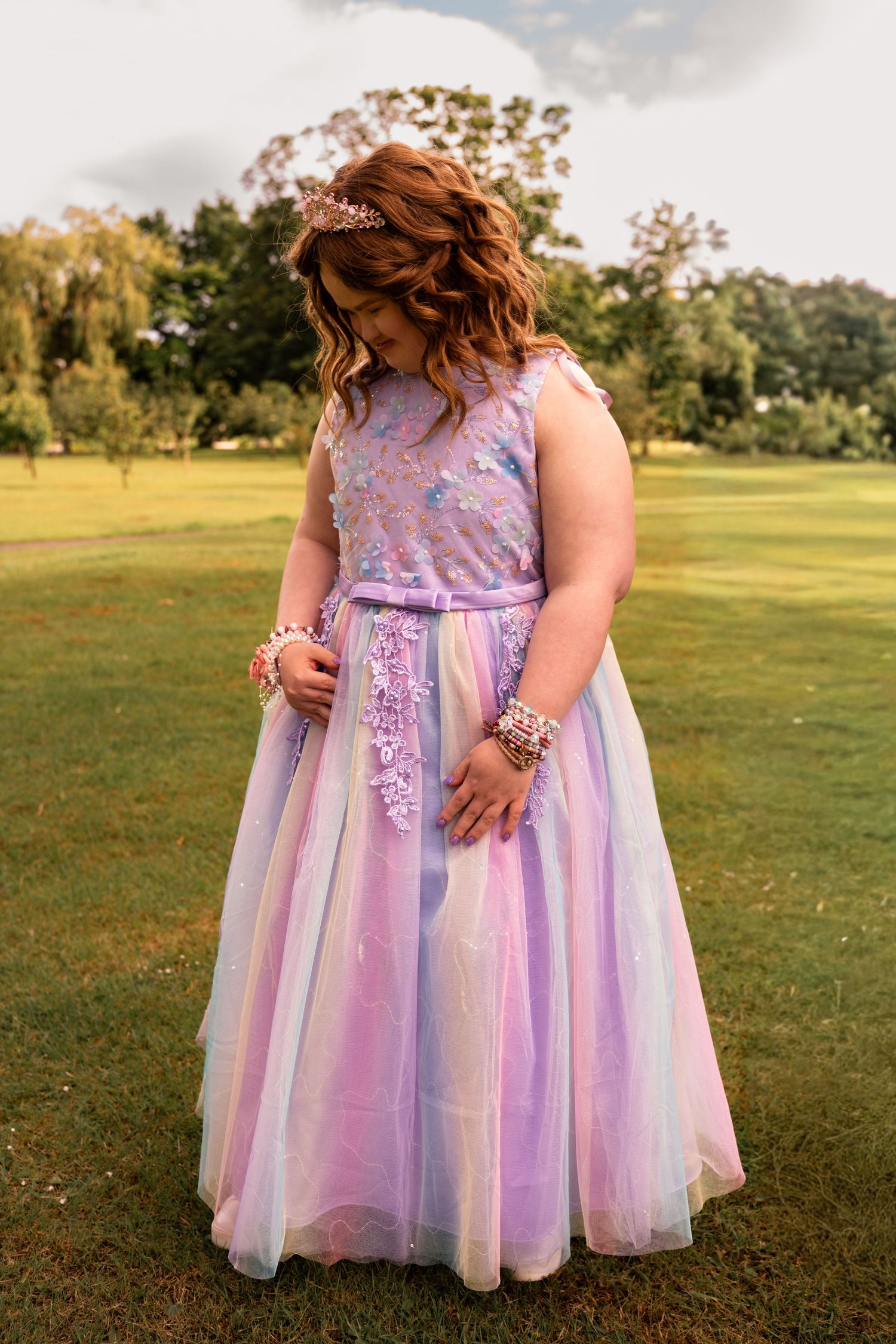 Grangemouth prom photography of a young girl in a pink and purple dress with crown posing at Zetland Park