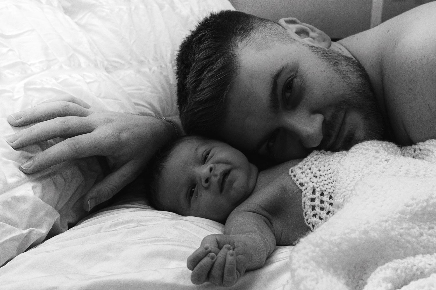 baby and dad photographed against a white background in the home.