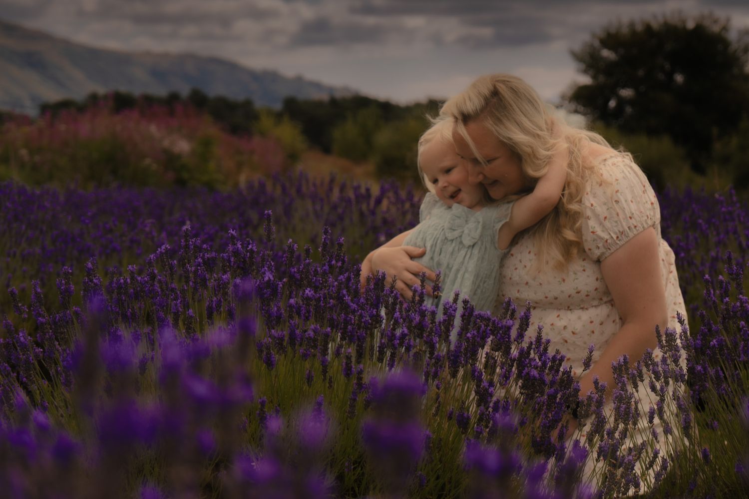 Daughter cuddling mum amongst the lavender fields at Scotland's Lavender Oils in Kinross,