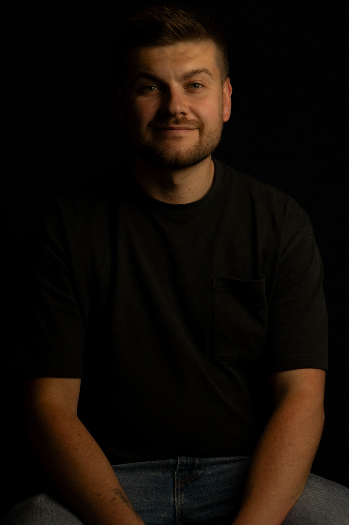 Headshot of male taken against a black background, North Lanarkshire.
