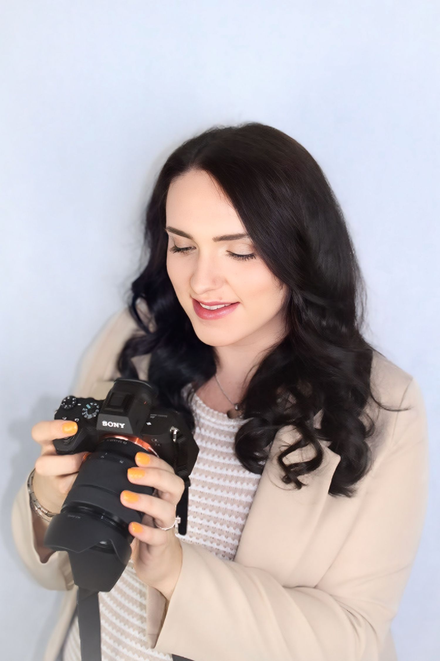 Photograph of myself, Lauren Thomson, owner of Lauren Thomson Photography. Pictured looking down at camera.