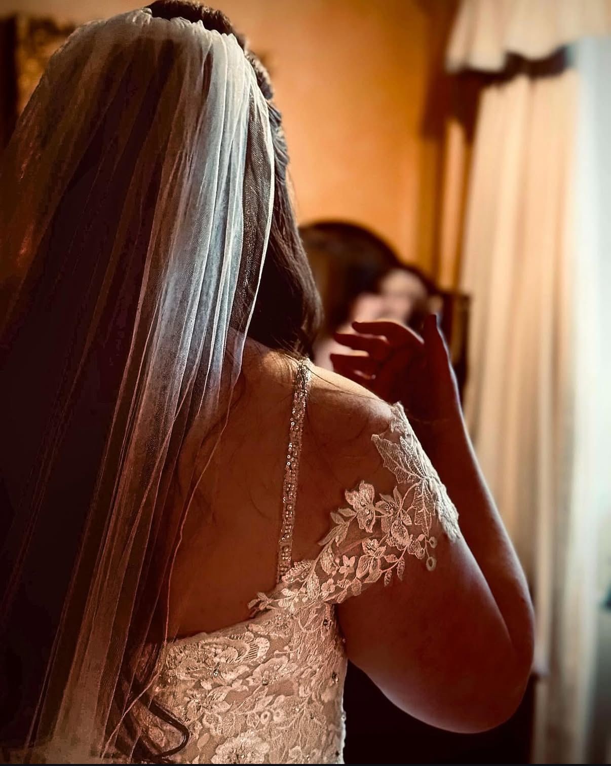 Bride photographed looking at finished makeup in the mirror, Fingask Castle.