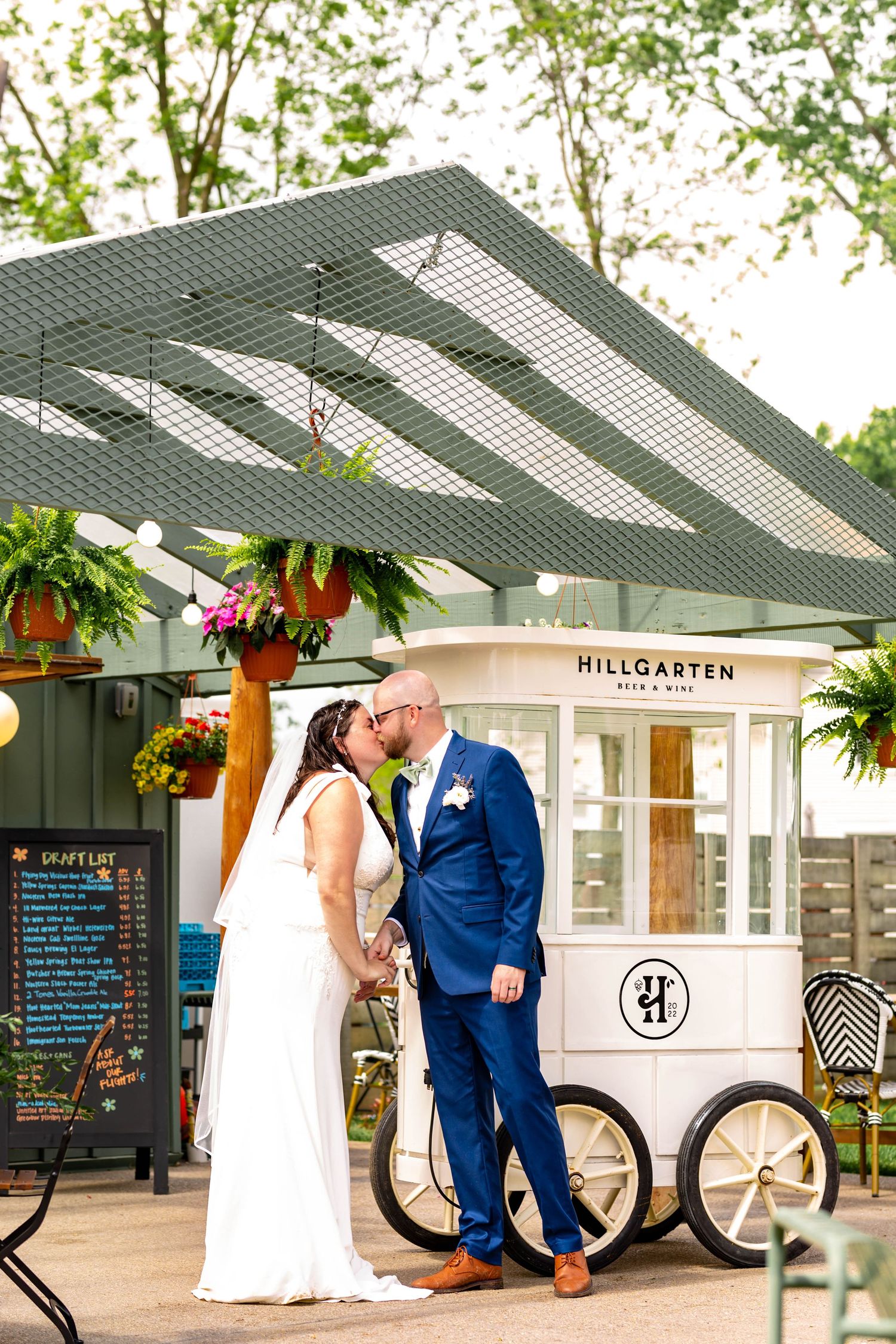 A rustic wedding venue with outdoor seating area and decorative hanging planters.