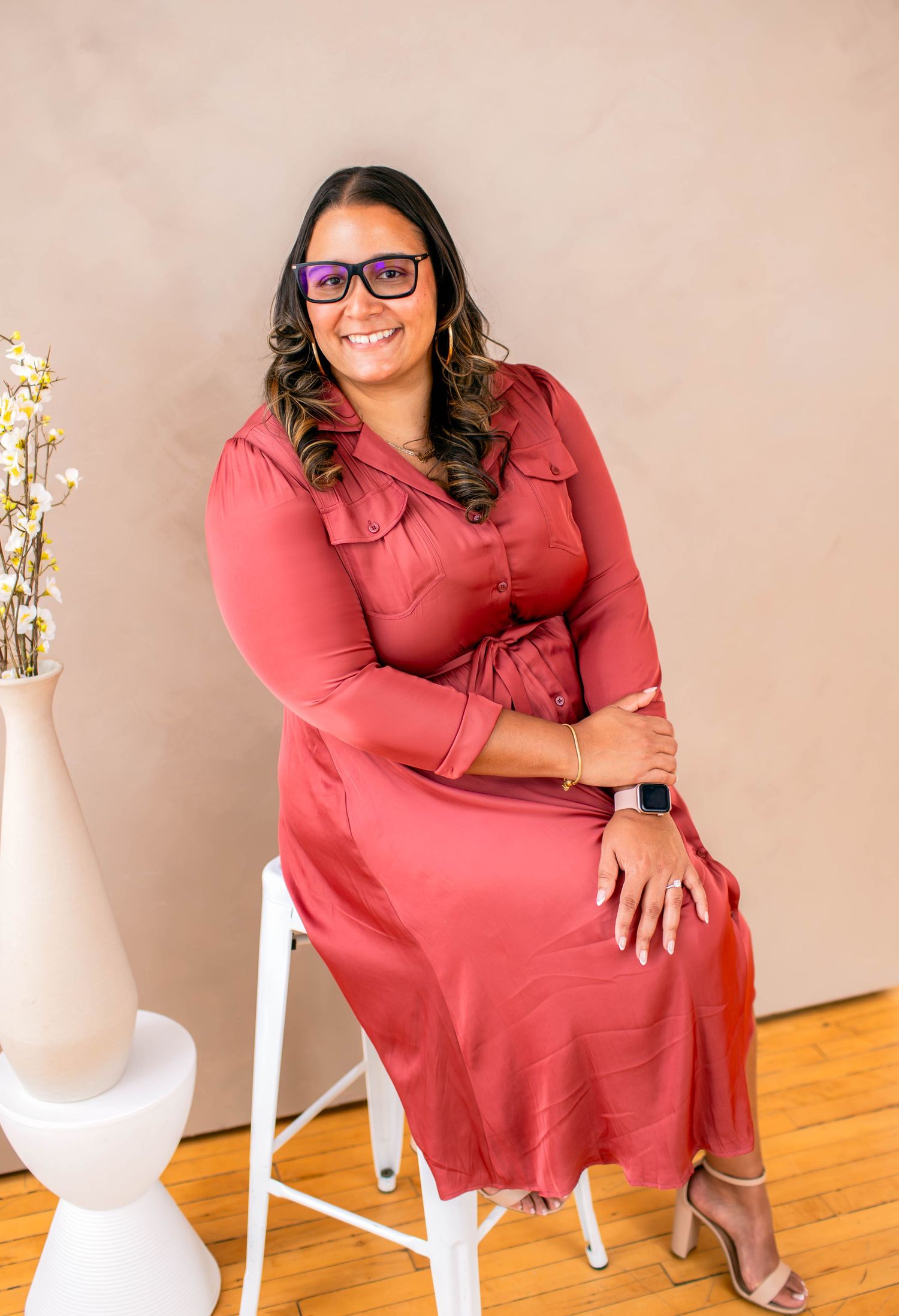 Portrait session featuring coral dress and casual poses against neutral background.