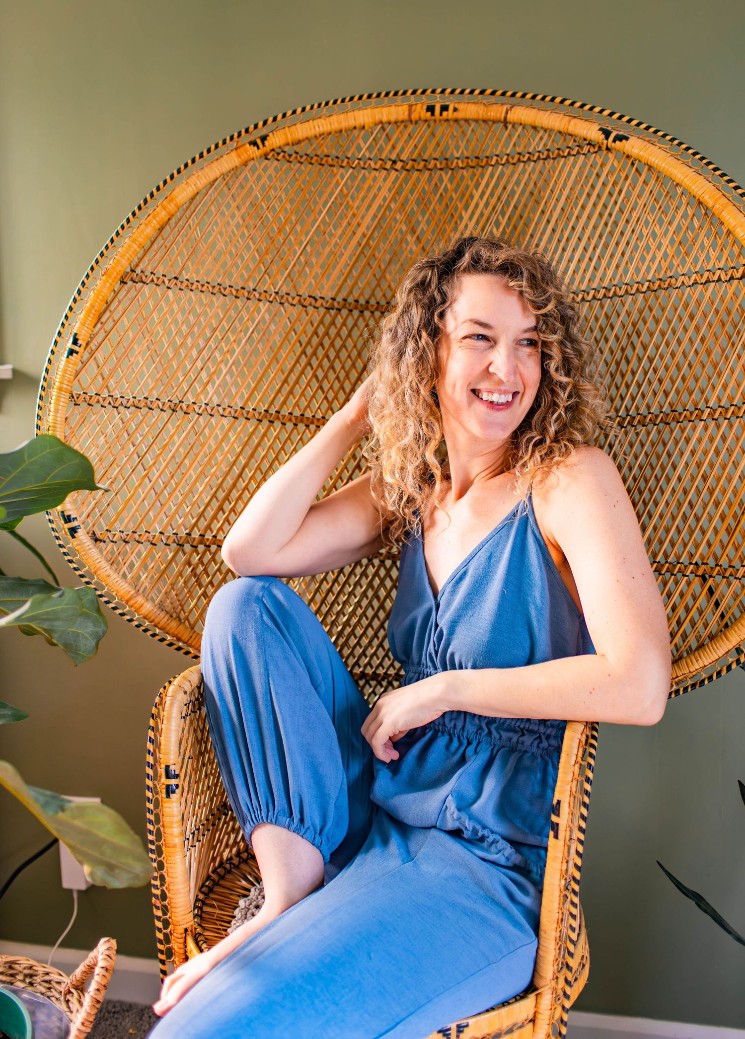 Casual portrait session on vintage wicker peacock chair with natural lighting.