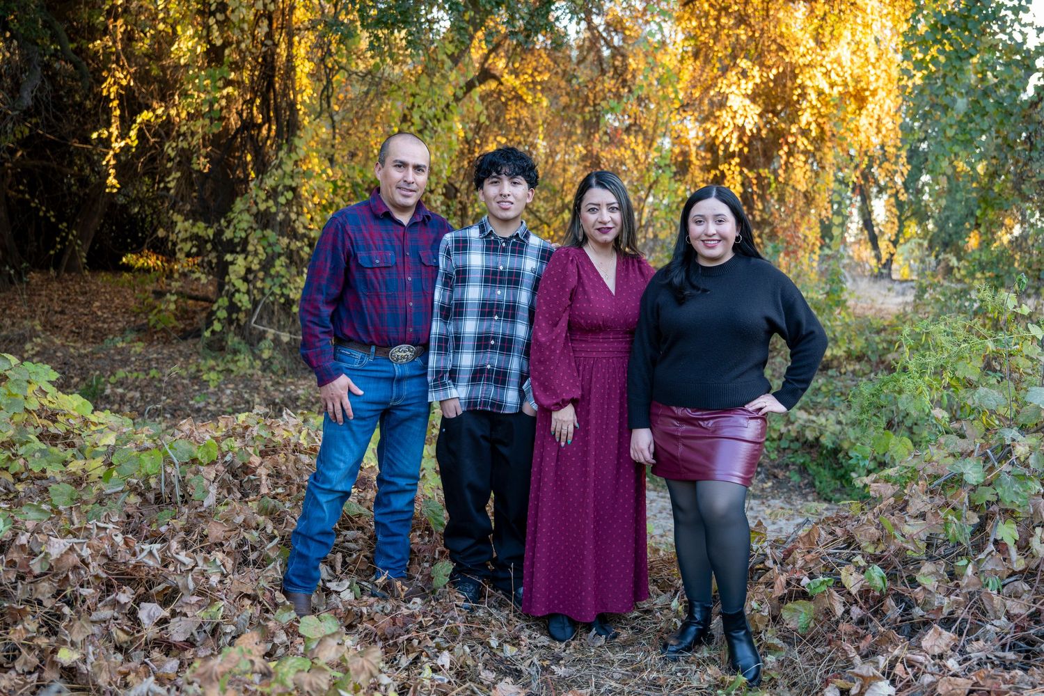 Family group photos outdoors with autumn foliage and fallen leaves in background.
