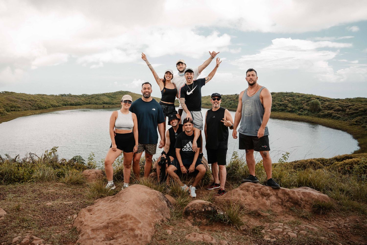 Group enjoying scenic views from a hilltop overlook during a hiking adventure.