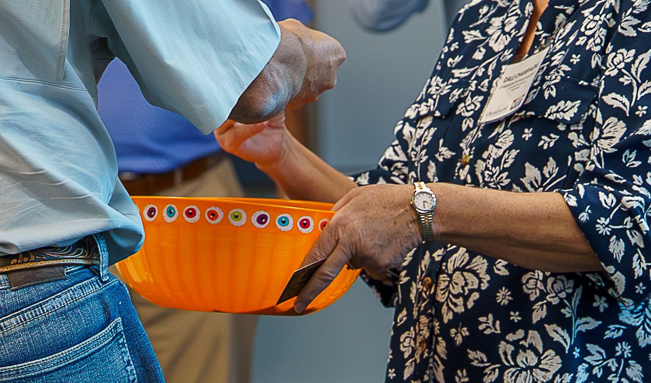 People exchanging items and materials during an event.