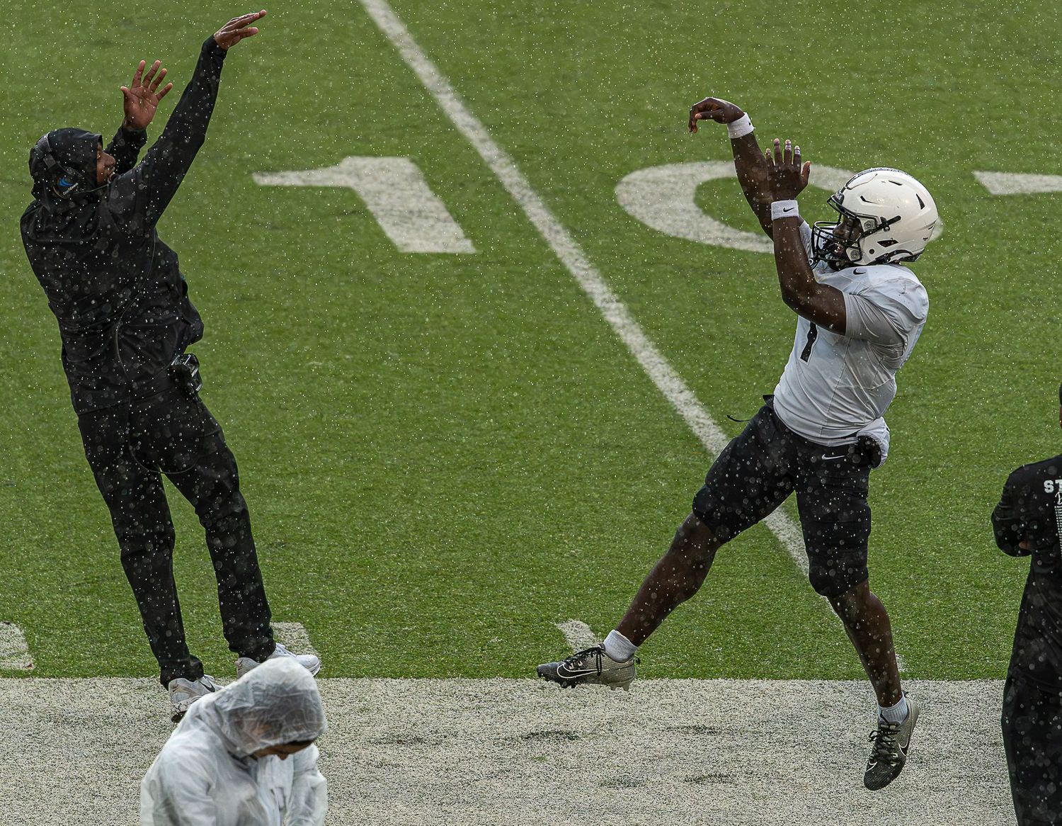 A sequence of football players performing kicking motions on a grass field during practice or training.
