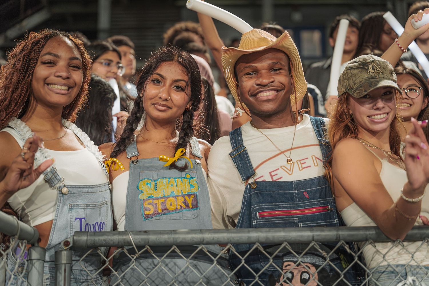 Diverse crowd of sports fans cheering enthusiastically at a stadium event.