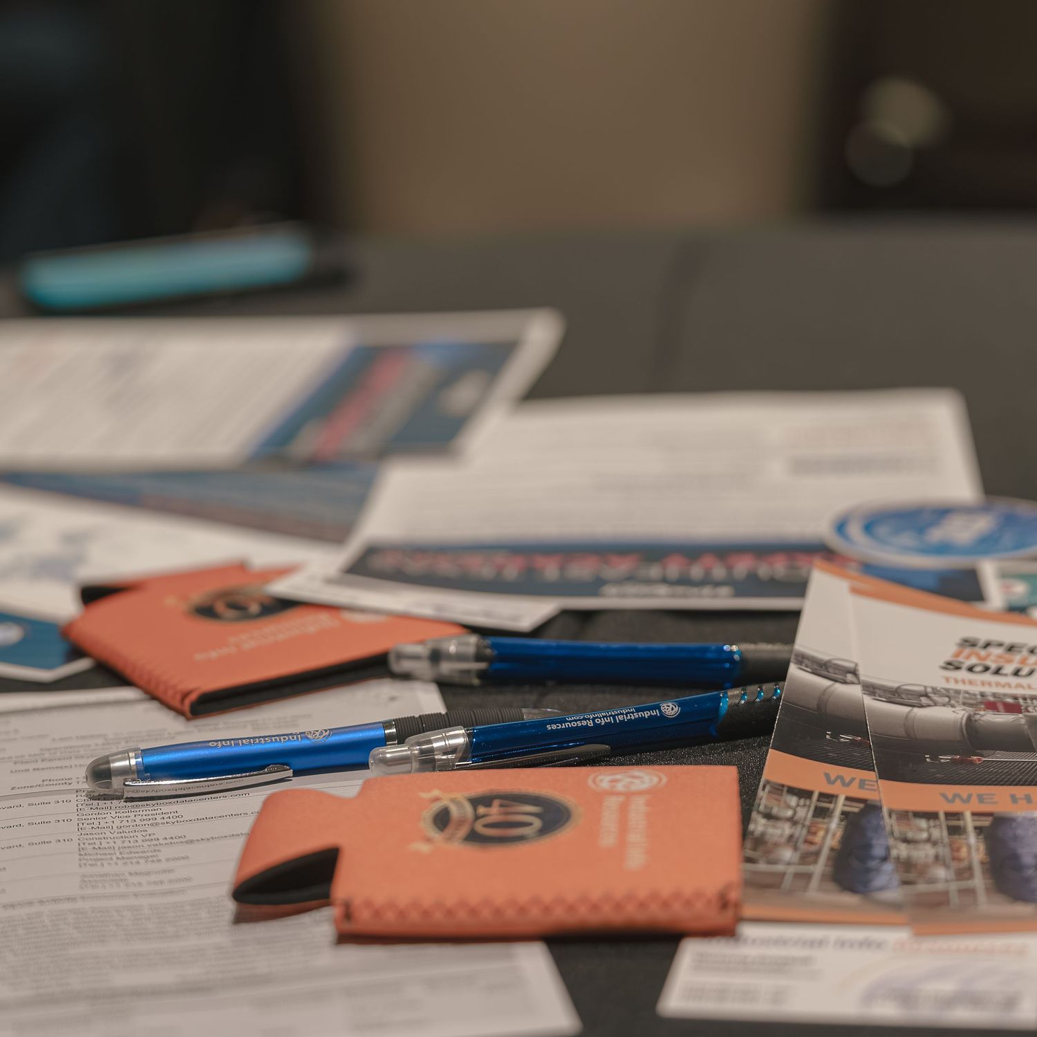 Various business cards and documents arranged on a desk surface.