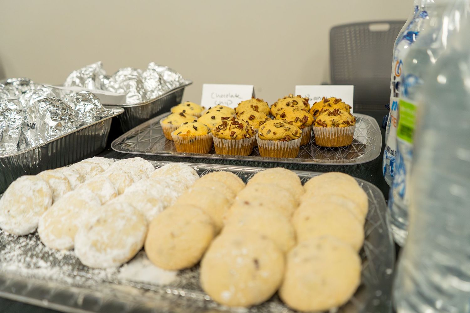 Assorted cookies and baked goods displayed on silver serving trays.