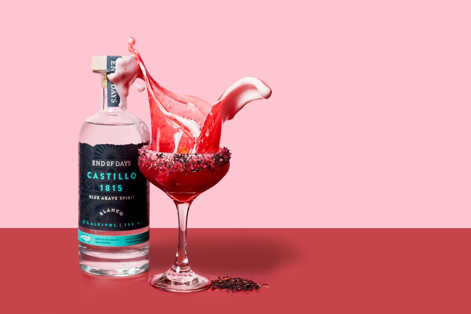 Pink cocktails splashing elegantly in martini glasses with dark garnishes against a pink backdrop.