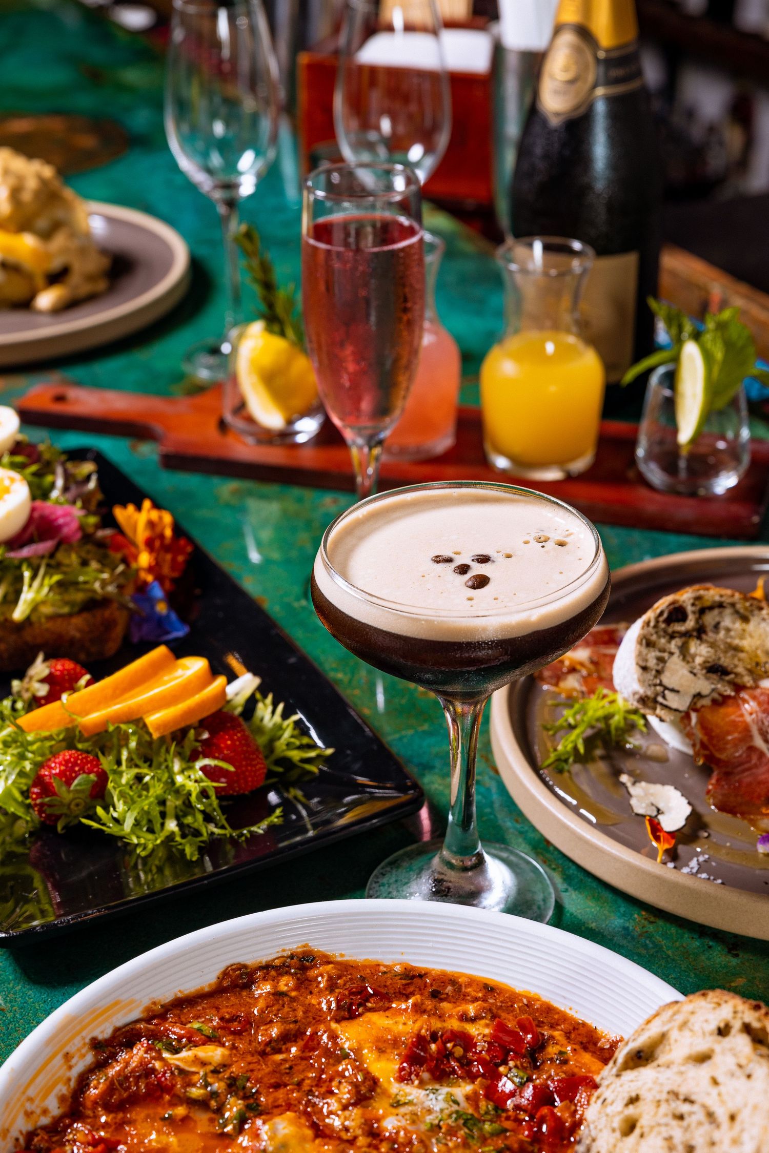 Elegant restaurant table setting with colorful plates and drinks.