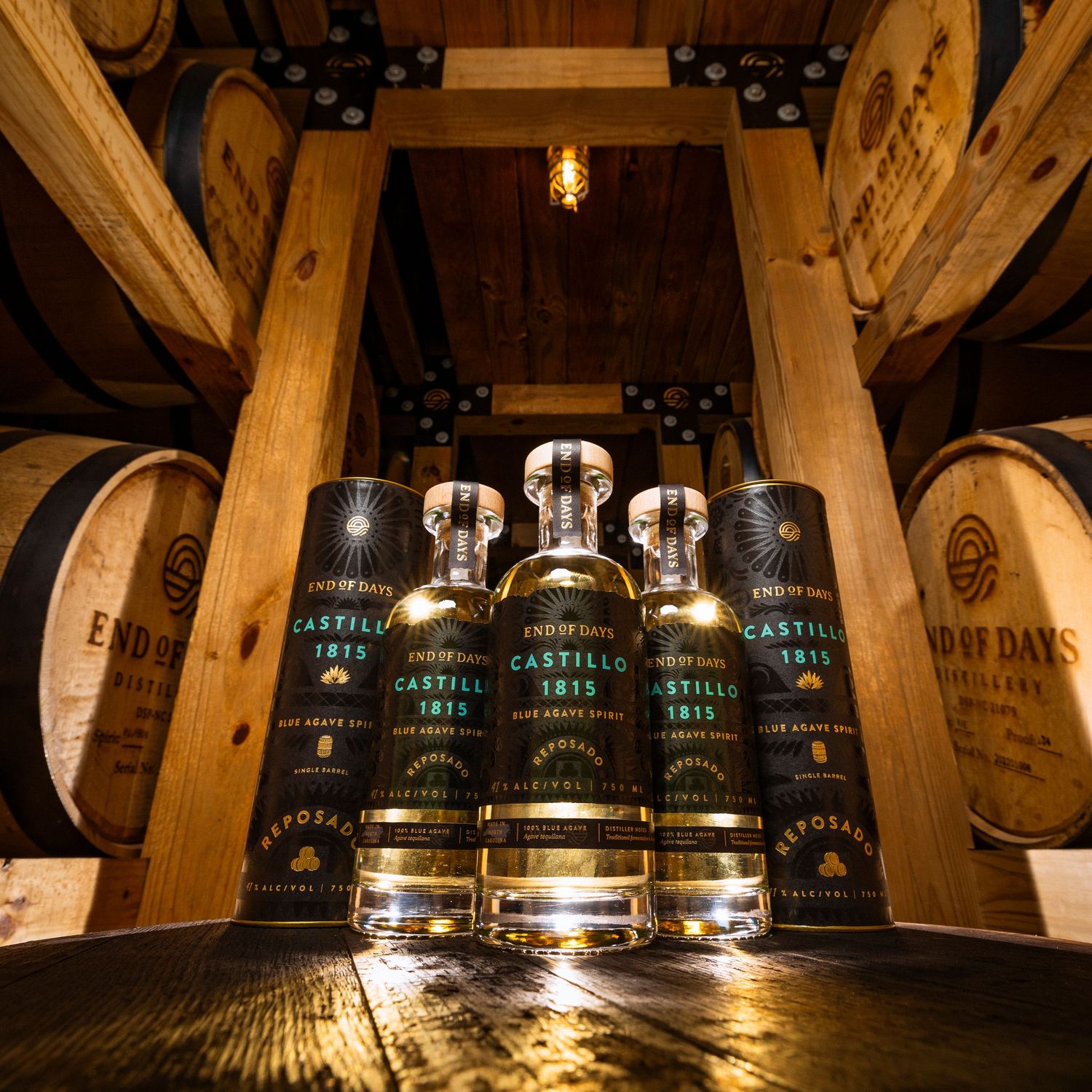 Whiskey bottles displayed on wooden shelves in rustic barrel storage room.