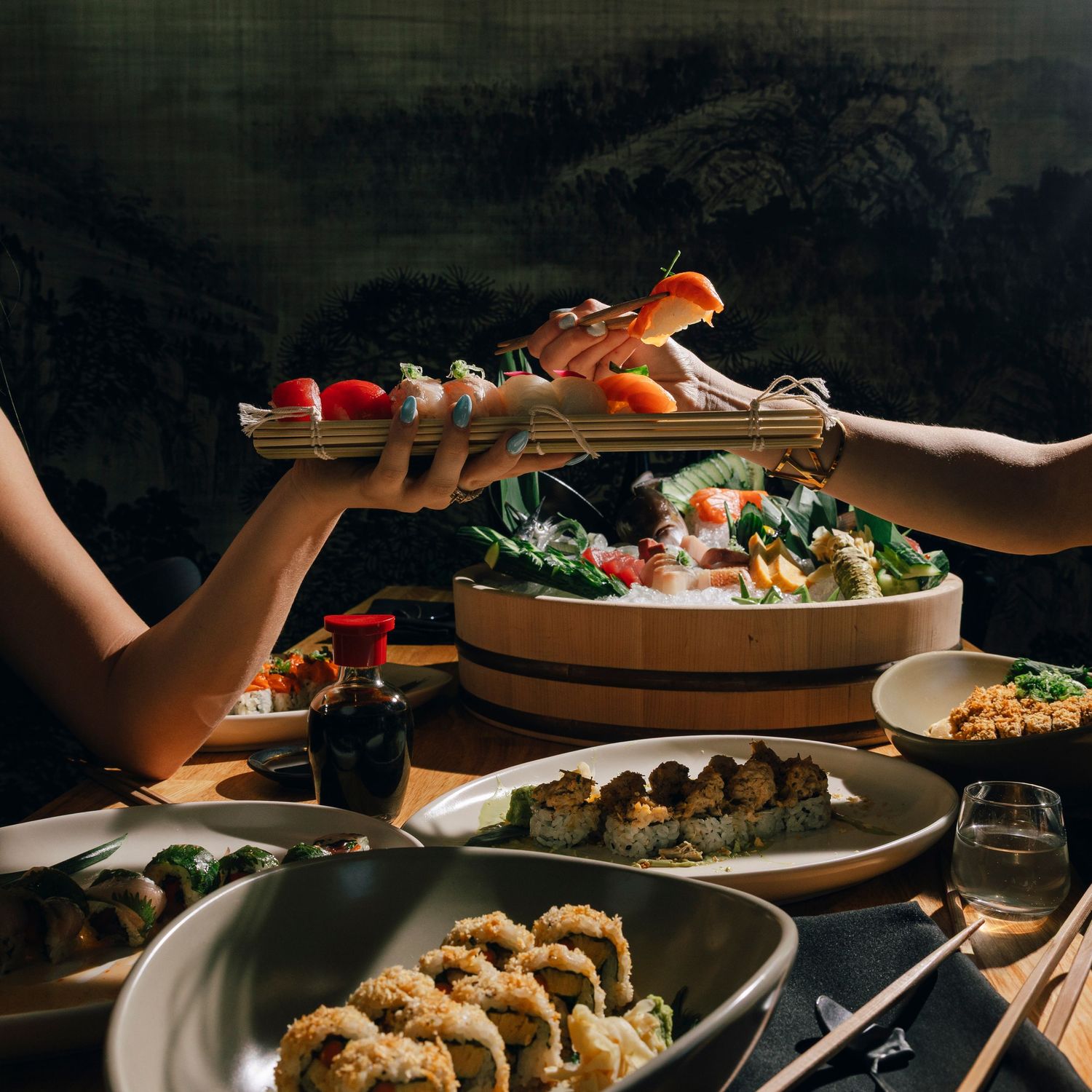 Overhead view of multiple plates with restaurant dishes being served.