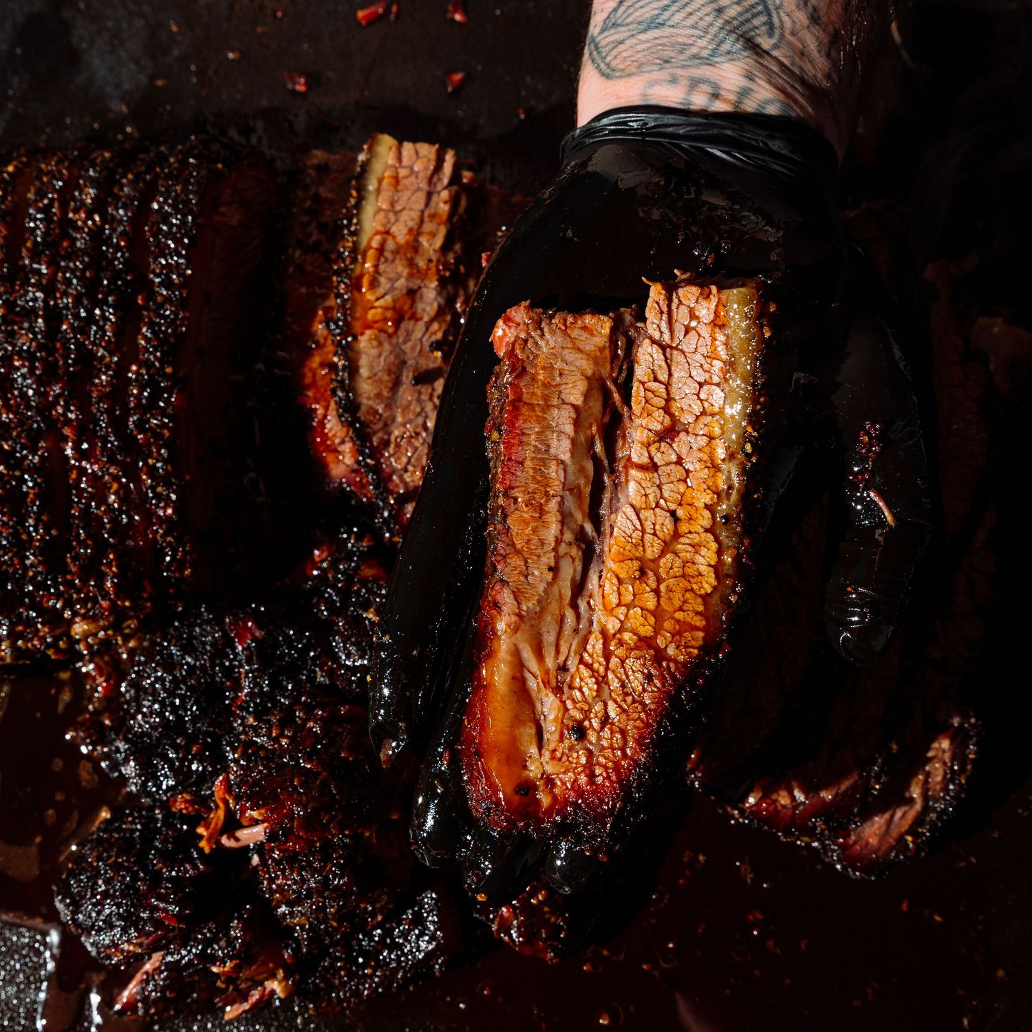 Charred and smoky BBQ ribs with blackened bark and caramelized edges.