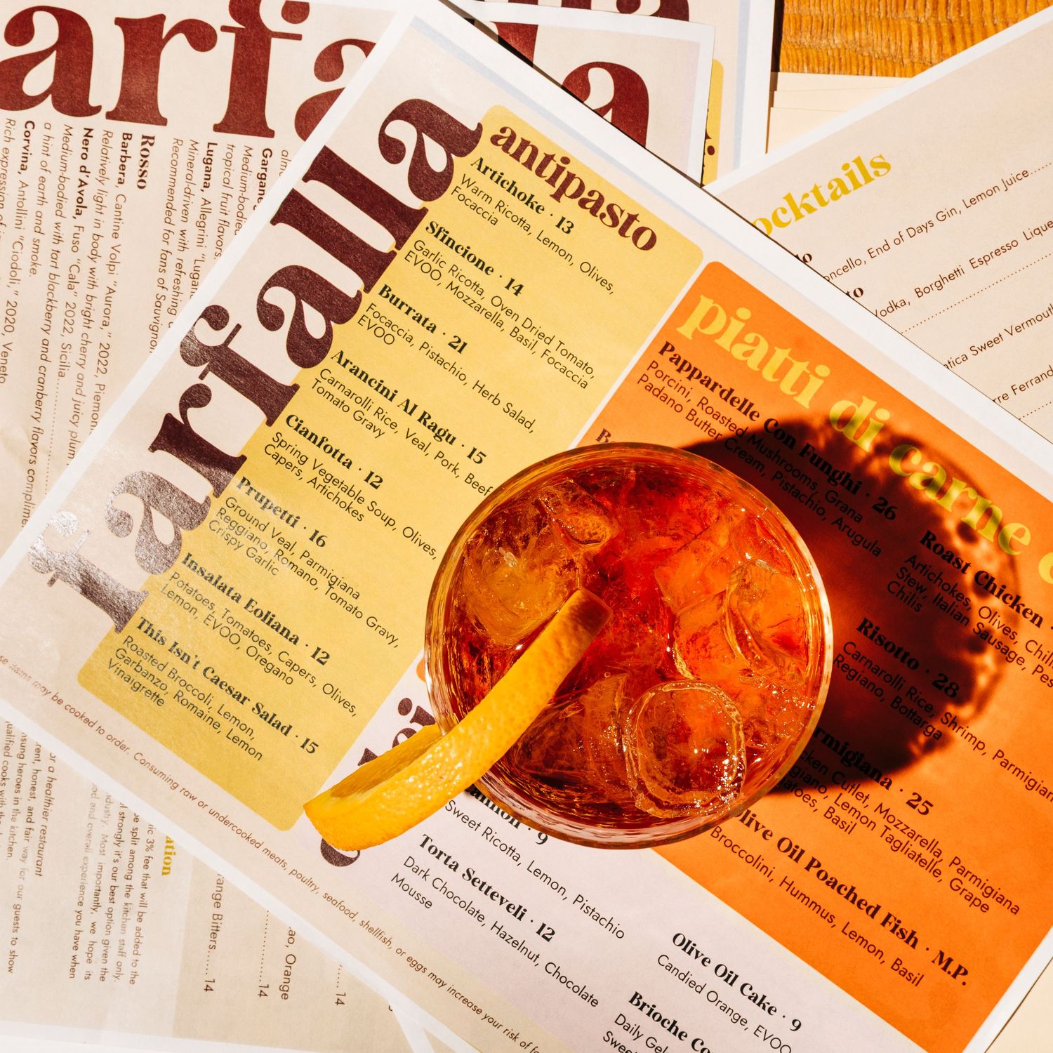 A refreshing cocktail served on ice with a menu in the background.