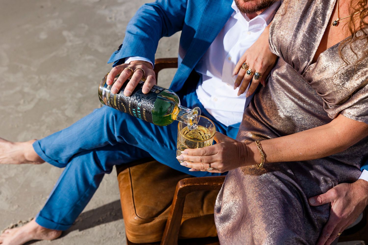 People relaxing outdoors with drinks in casual attire.