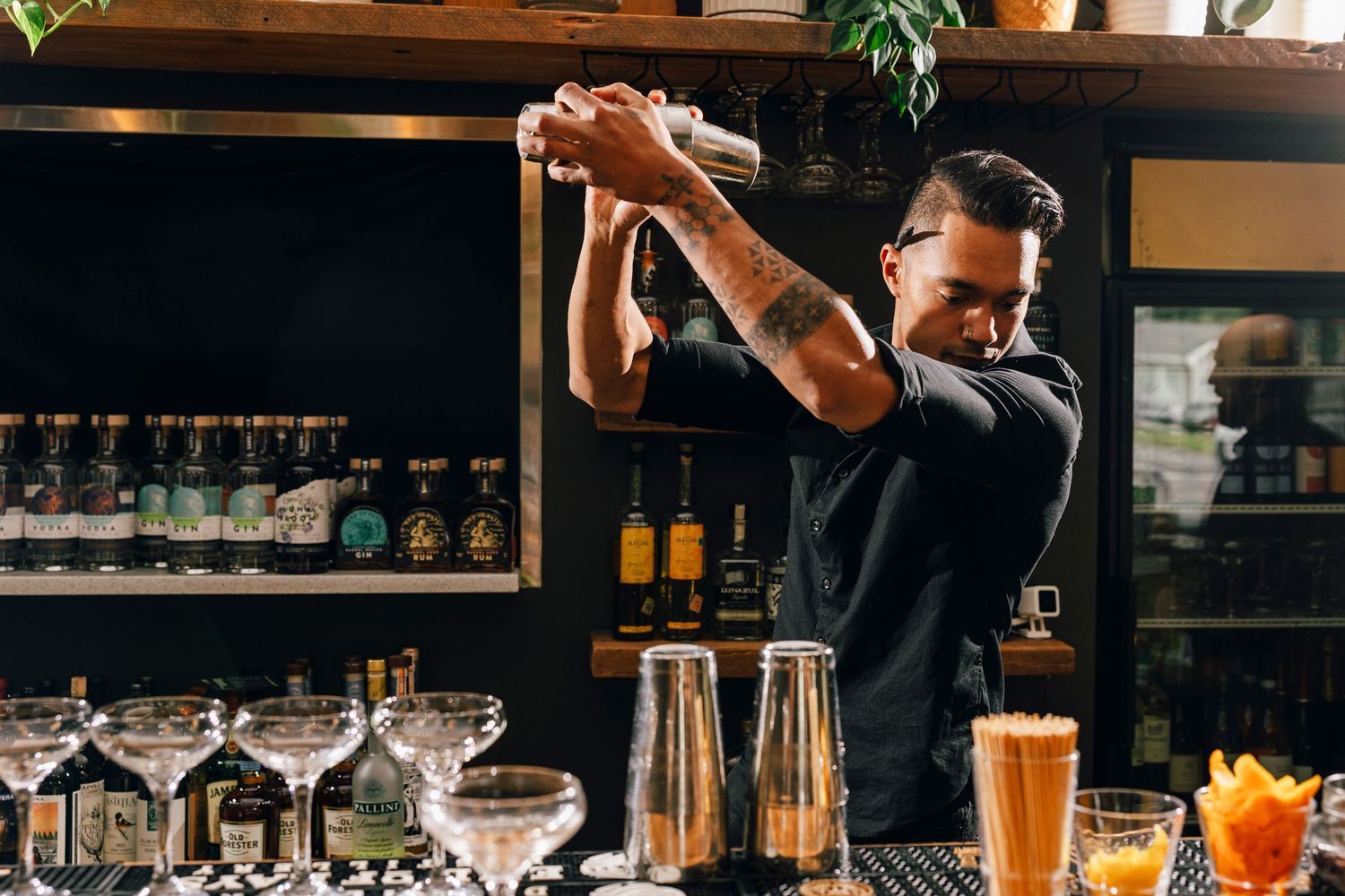 Bar interior with expertly crafted cocktails and professional mixology equipment on display.