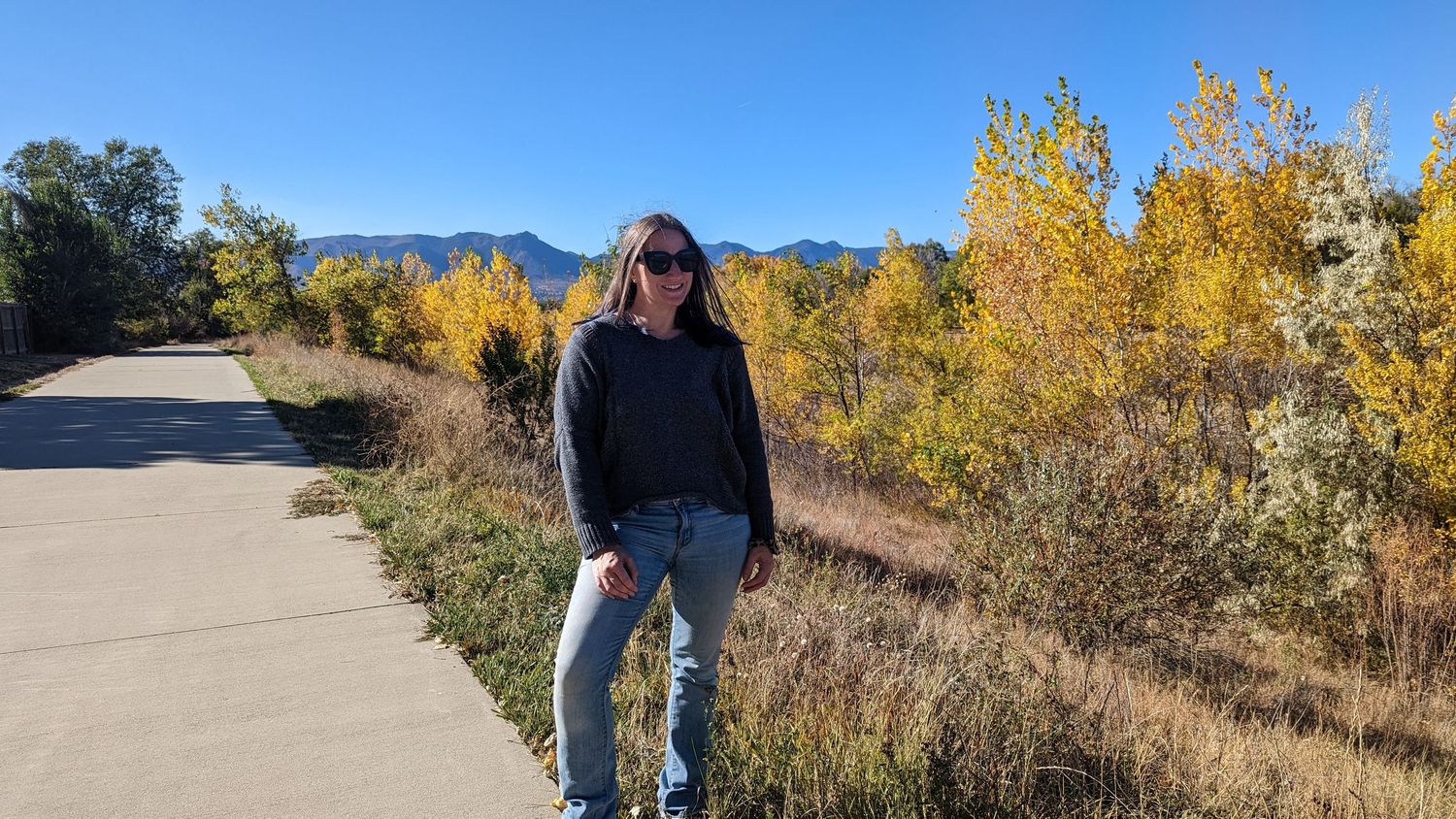 Portrait of me Andi Adams  on Cottonwood Creek Trail in fall with golden leaves and blue sky
