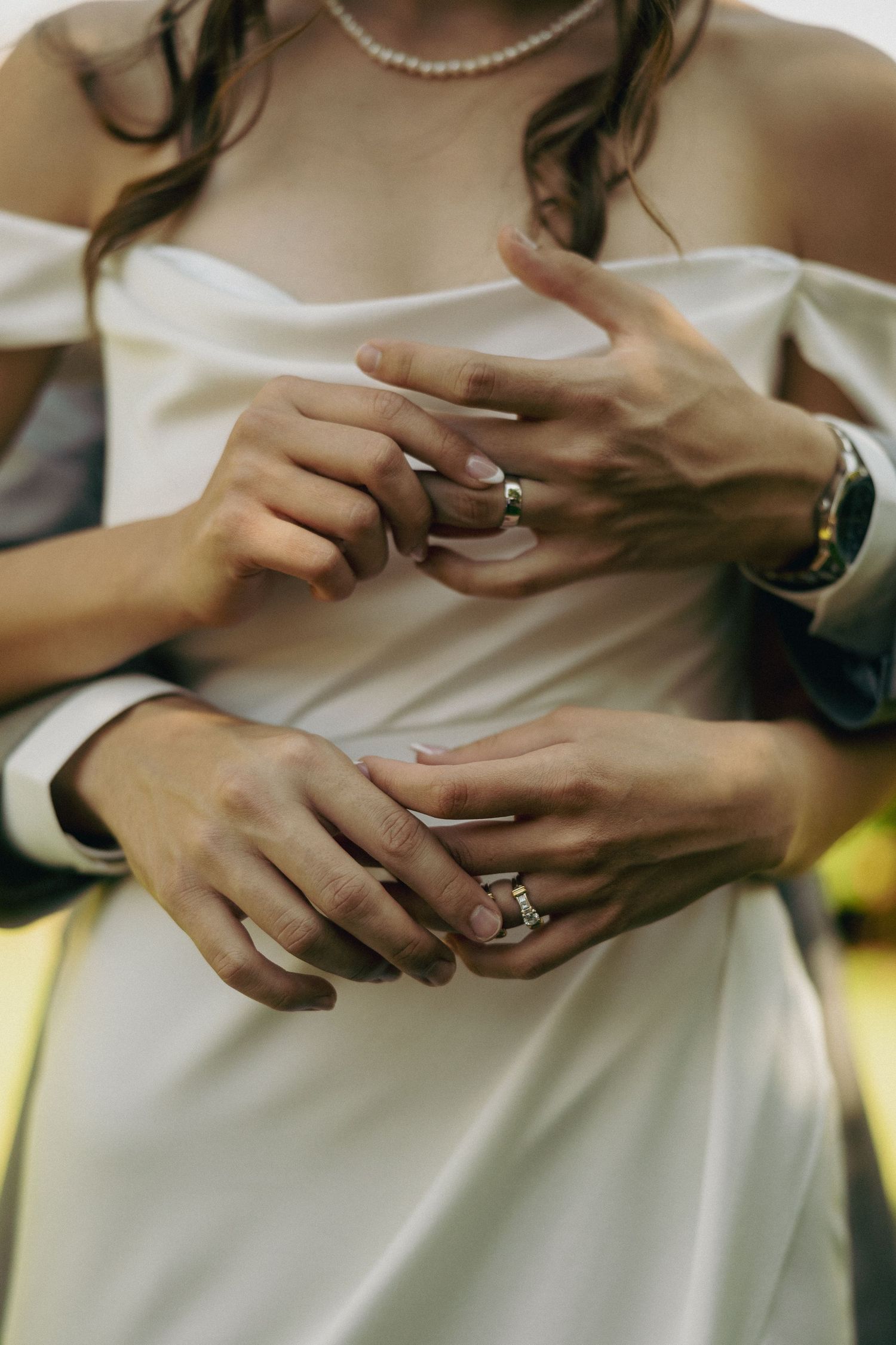 Close-up sequence showing hands exchanging wedding rings during a ceremony.