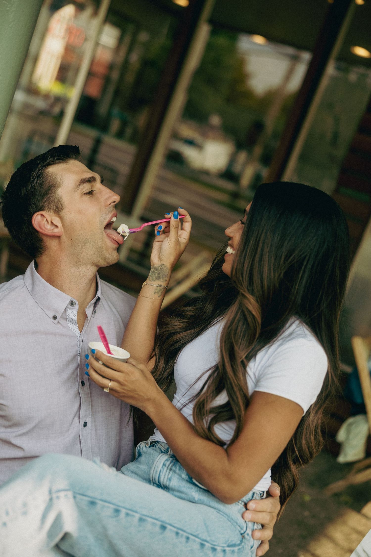Couple sharing ice cream cones together on a playful date.
