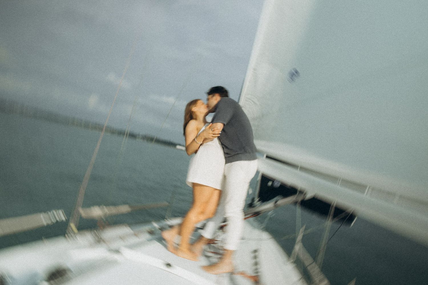 A couple enjoying intimate moments aboard a sailing vessel.
