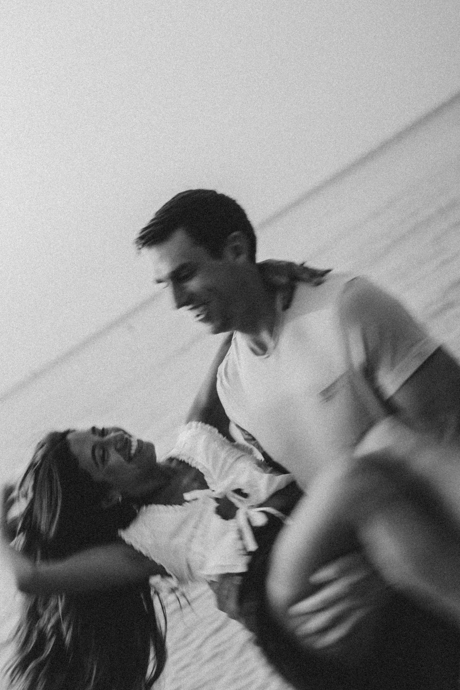 Intimate black and white portrait of a couple sharing a tender moment.