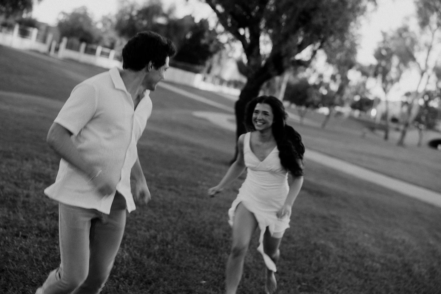 Candid black and white wedding moments captured outdoors on a sunny day.