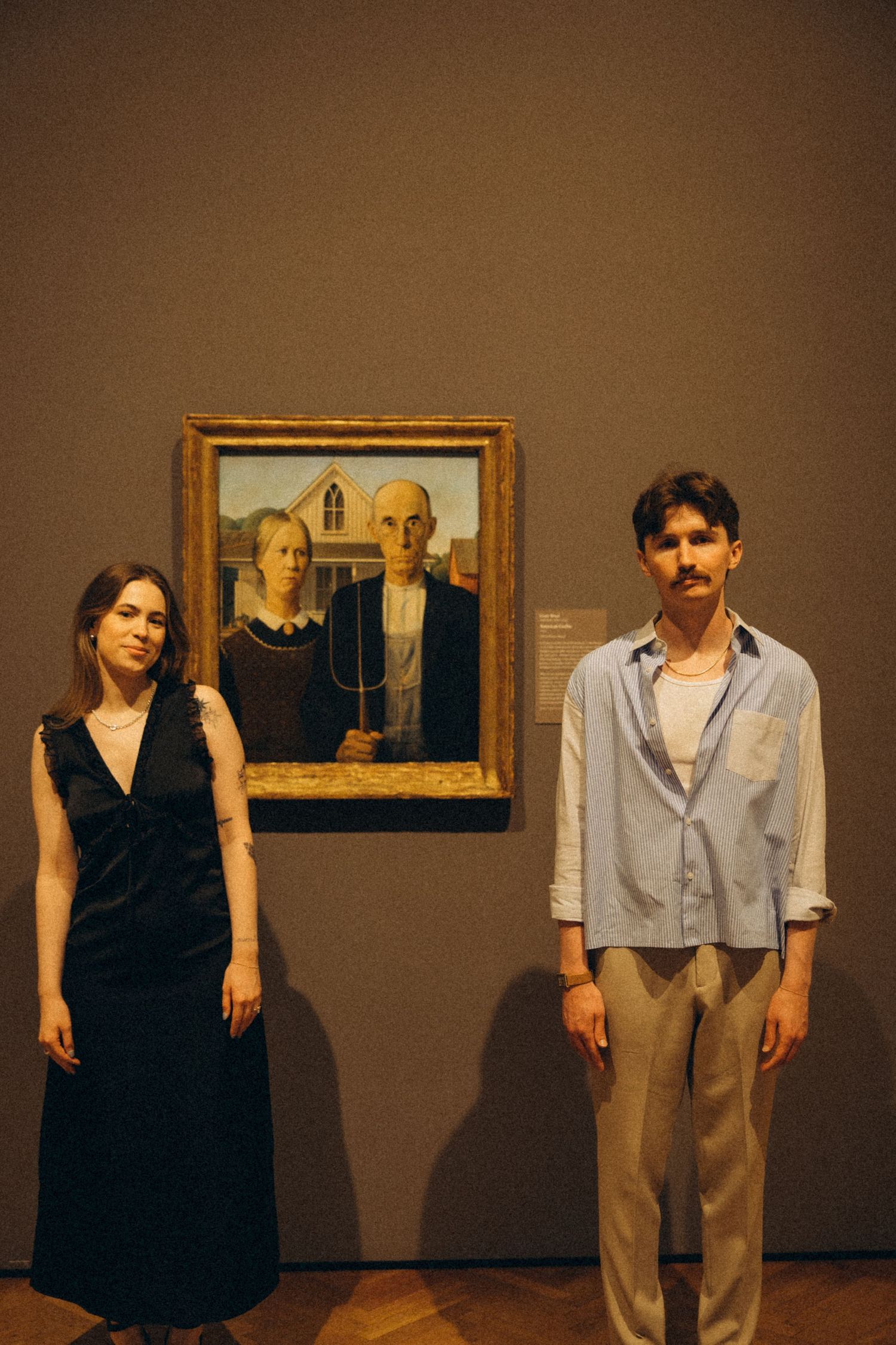 Artistic performance sequence in an art gallery with framed paintings on the wall.