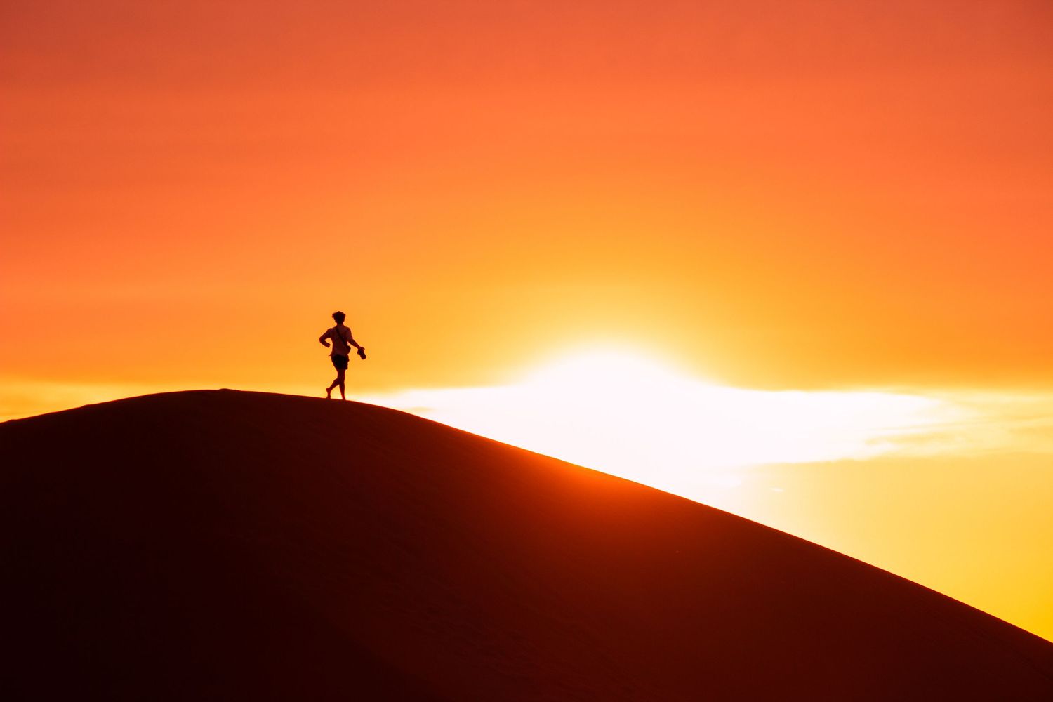 Orange and yellow sunset sky with silhouetted figure on hilltop in progressive sequence.