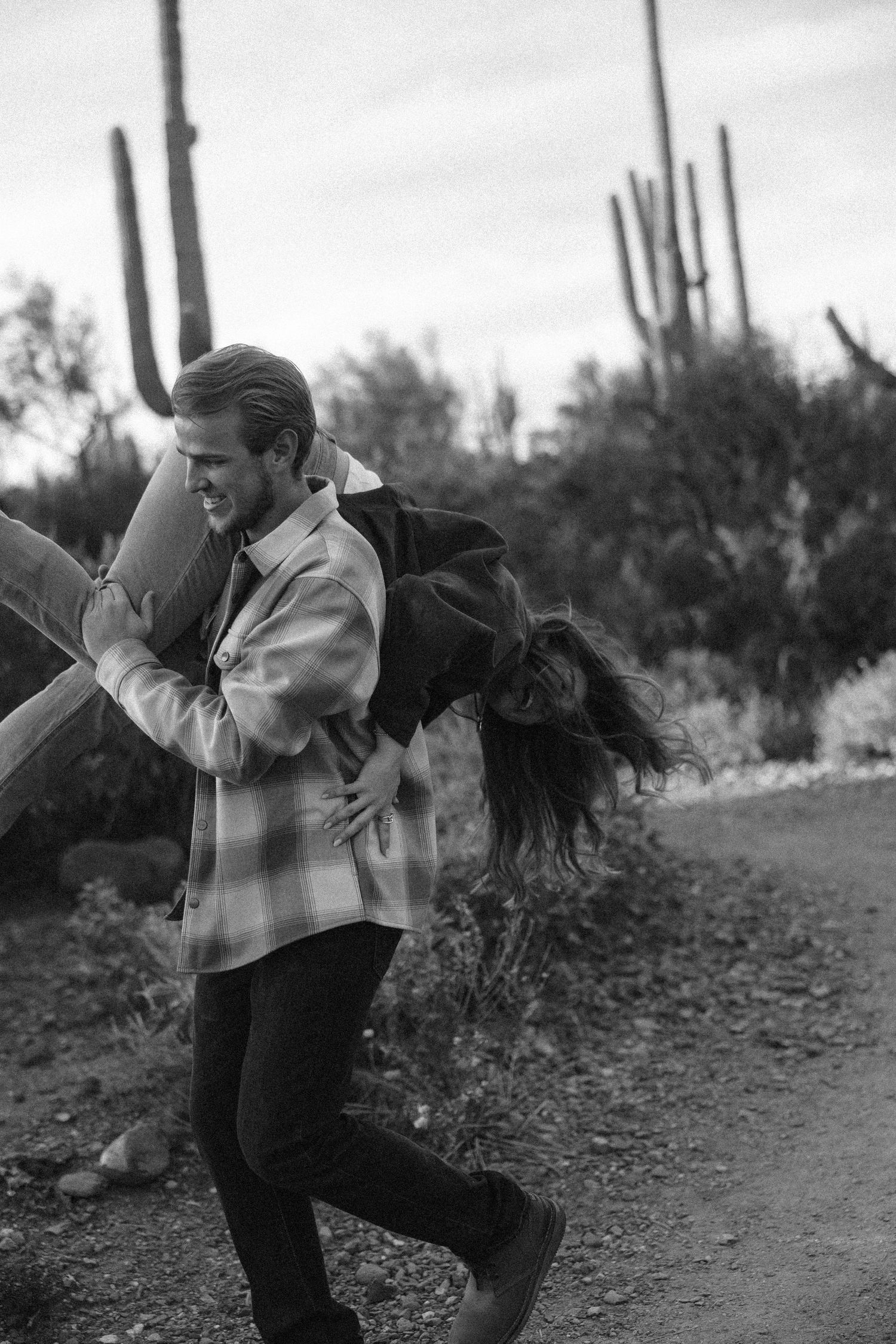 A black and white sequence shows a dancer performing dynamic movements against a desert landscape with saguaro cacti.