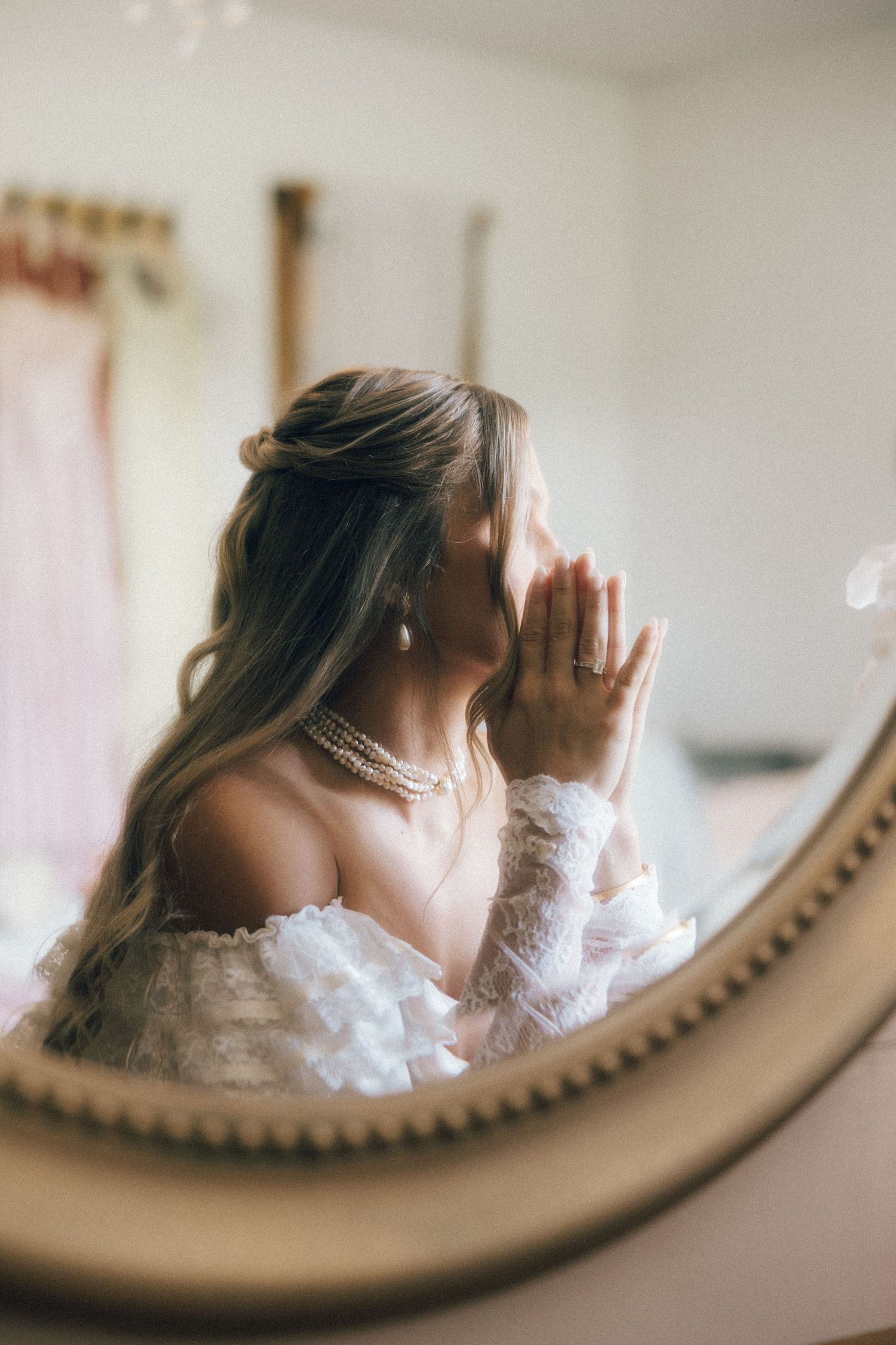 Delicate lace details reflected in an ornate mirror with soft lighting.