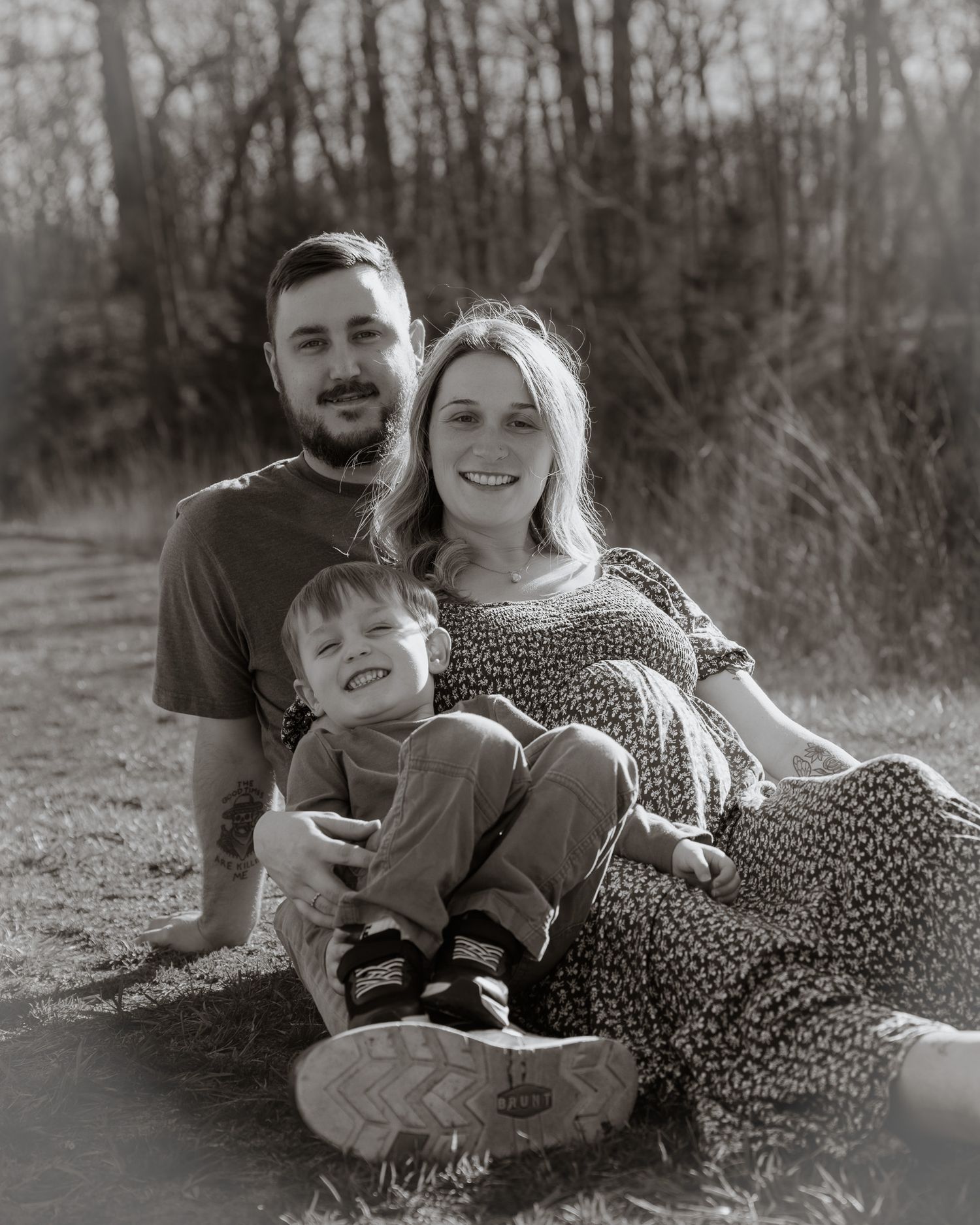 A family relaxing outdoors on a winter day, captured in black and white photography.