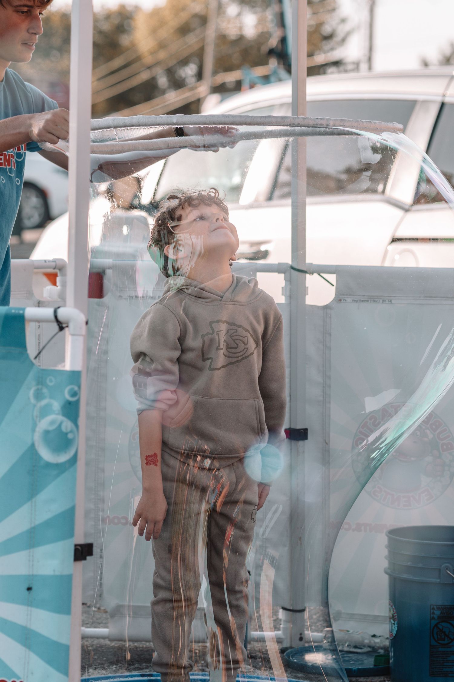 Multiple exposure shot of someone blowing bubbles on a boat deck with reflective glass panels.