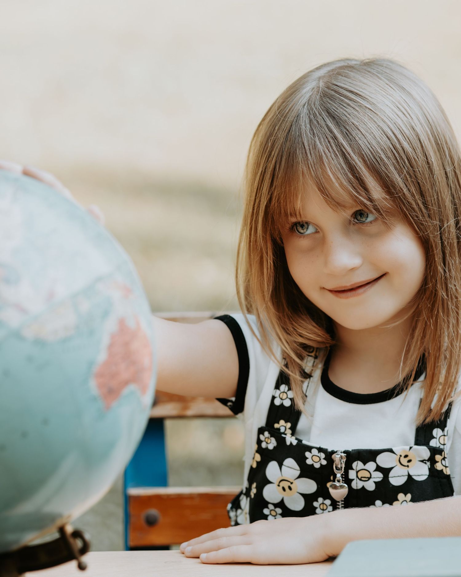 A sequence of photos showing someone leaning over and interacting with a globe or spherical object.