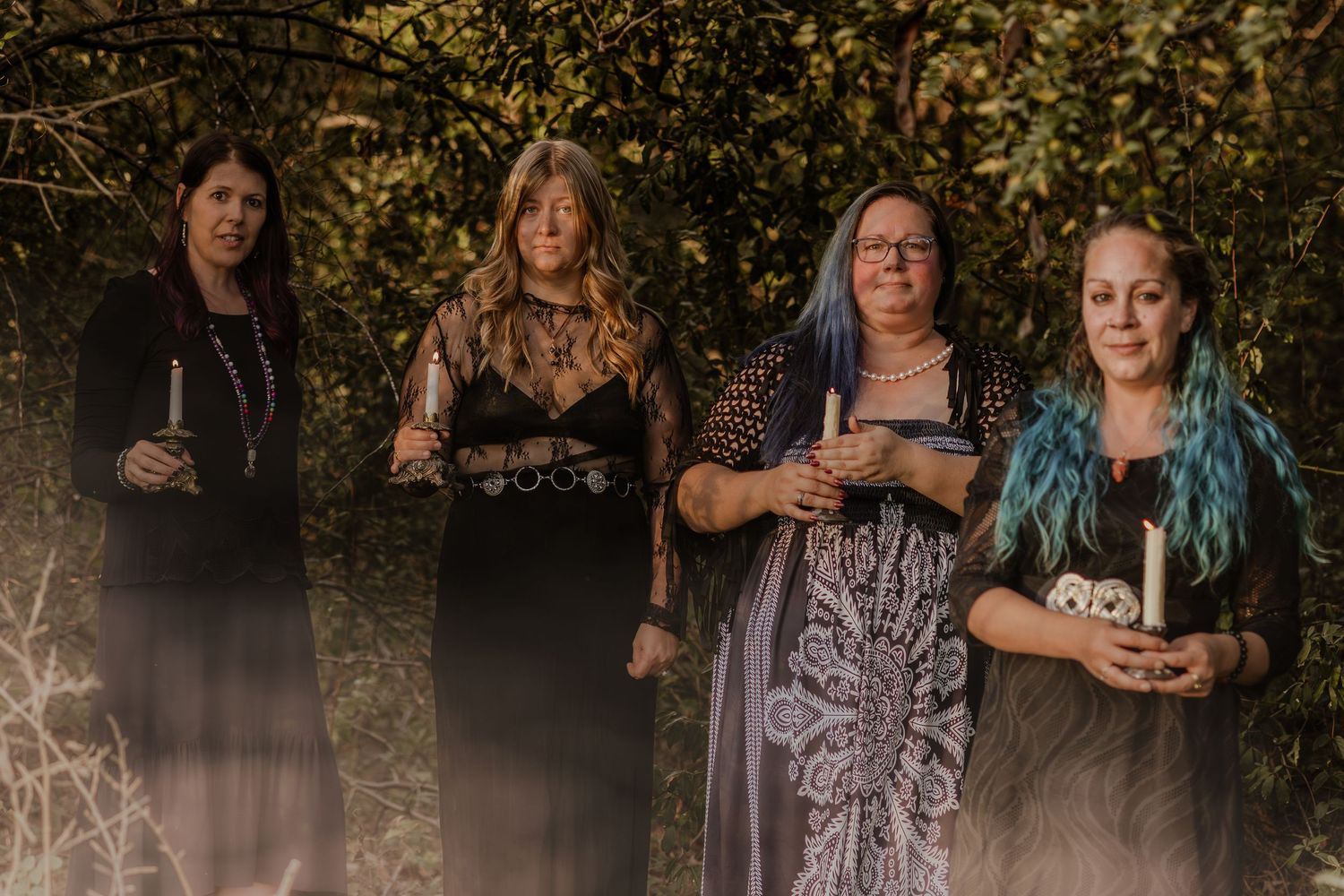 Group portrait series in dark clothing against autumn foliage background.
