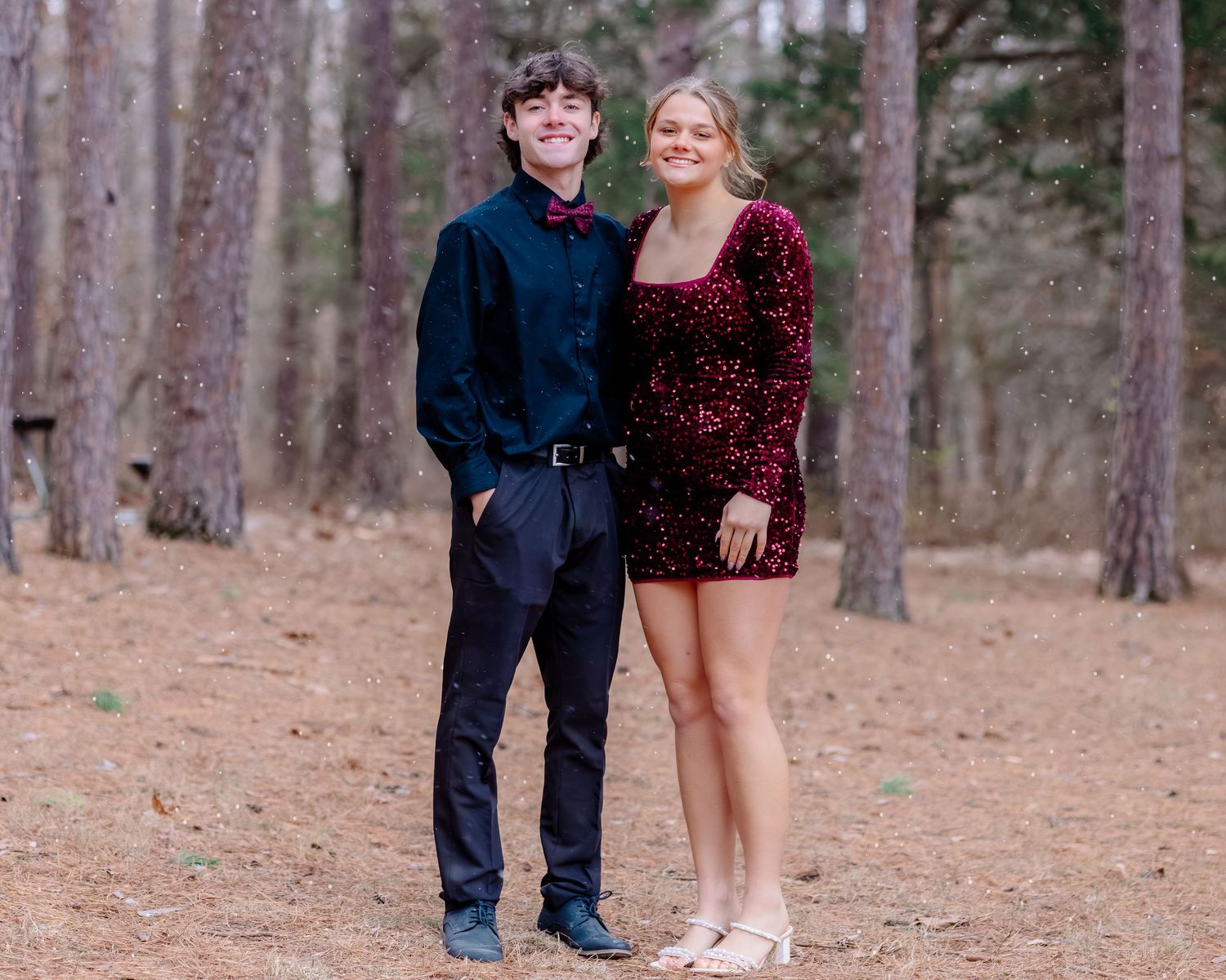 Couples posing for photos in a pine forest with formal outfits.