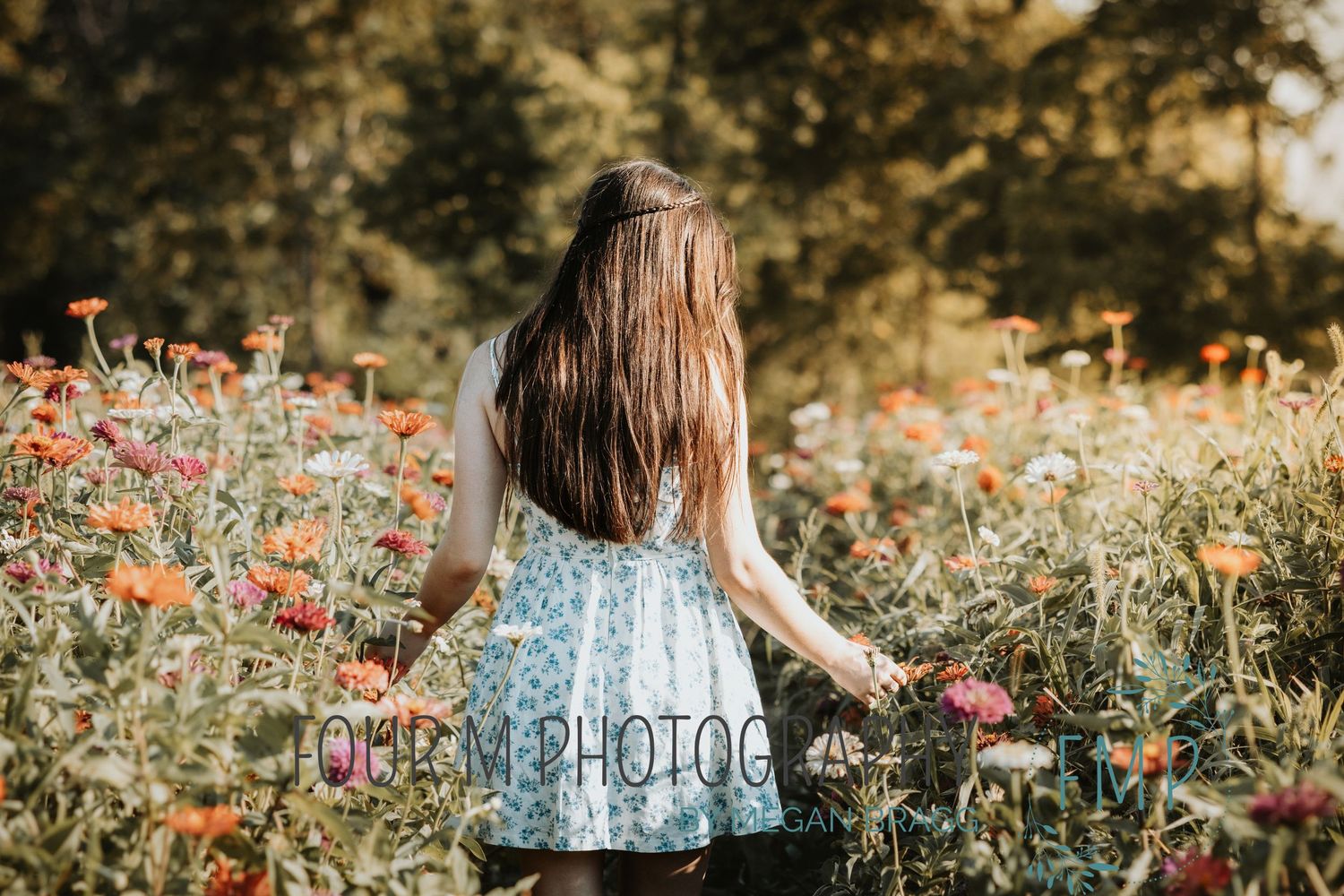 A person in a floral dress walks through a vibrant wildflower garden during golden hour sunlight.