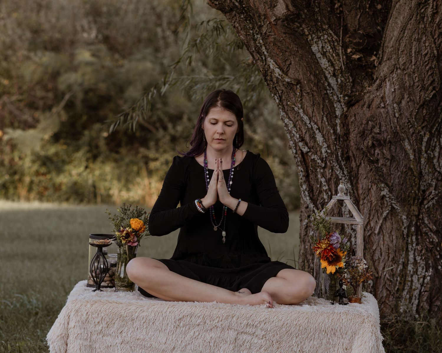 Peaceful meditation scene outdoors with decorative elements and natural backdrop.