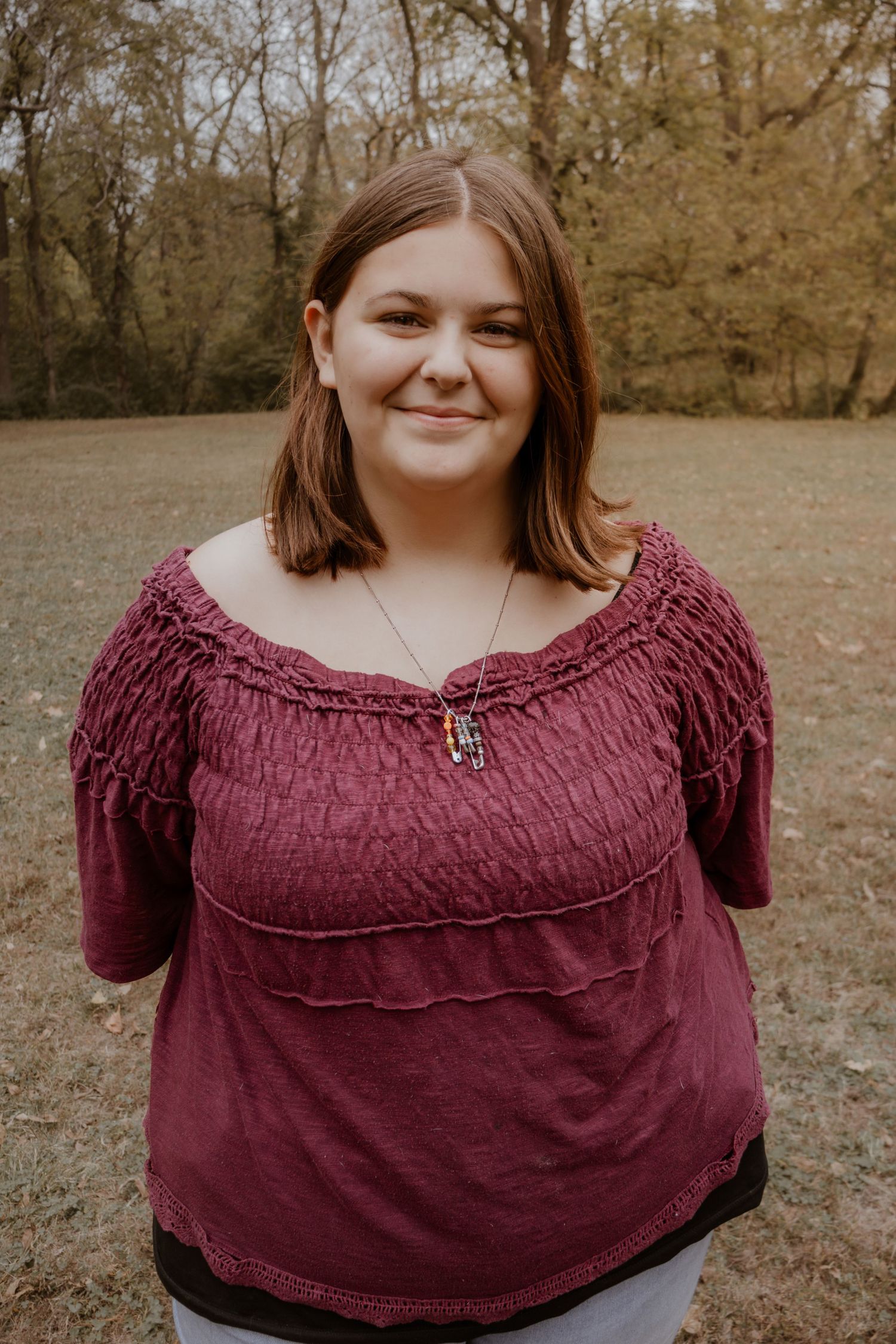 A series of outdoor portrait shots showing someone wearing a burgundy off-shoulder top in an autumn setting.