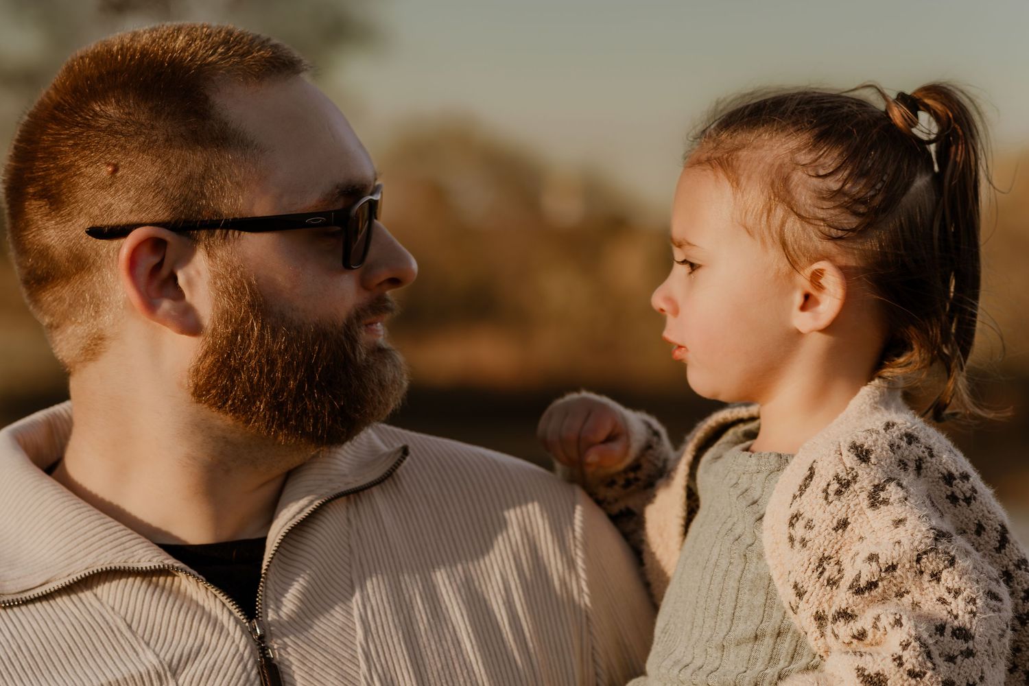 Intimate family portrait session with warm golden lighting and natural expressions.