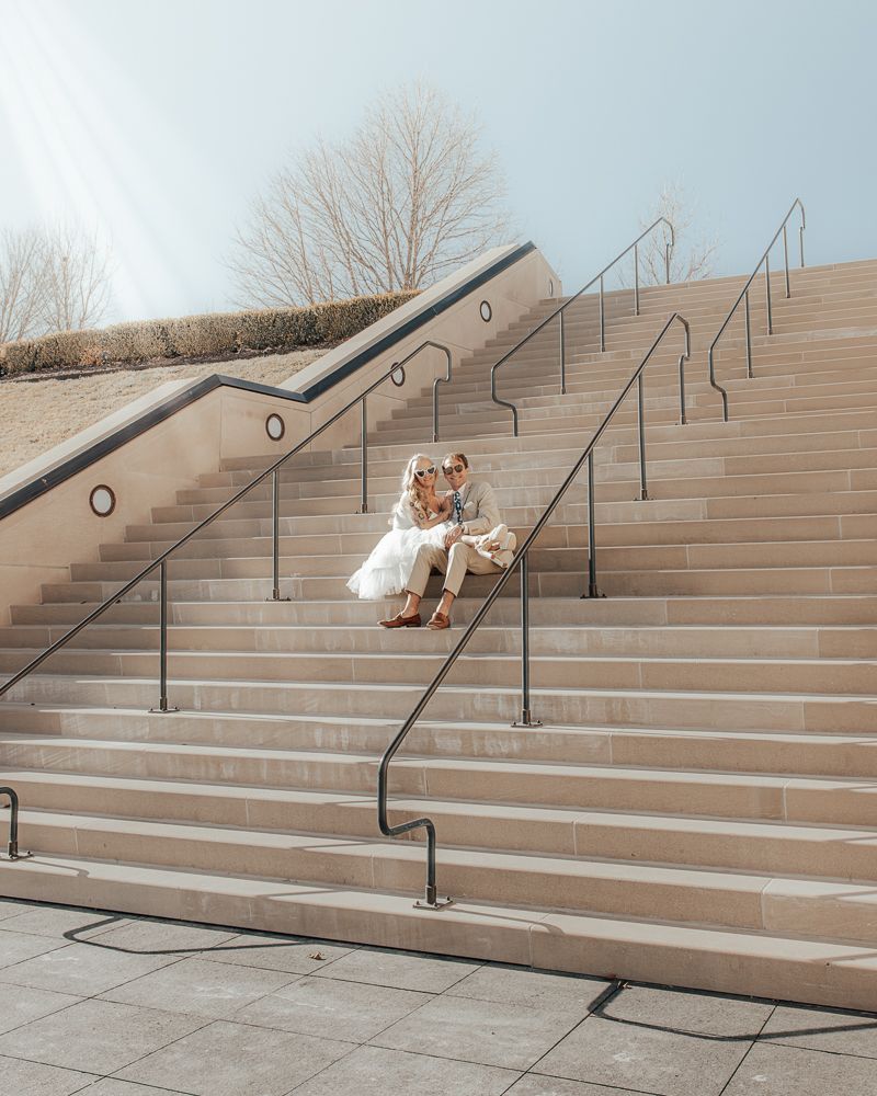 A sequence of photos showing a couple rolling playfully down concrete steps in a romantic moment.