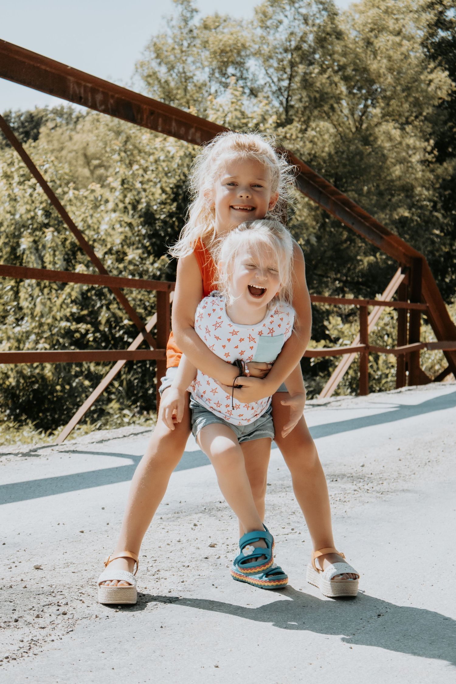 A sequence of candid shots showing a toddler in a polka dot outfit playing and bending down on a concrete surface outdoors.