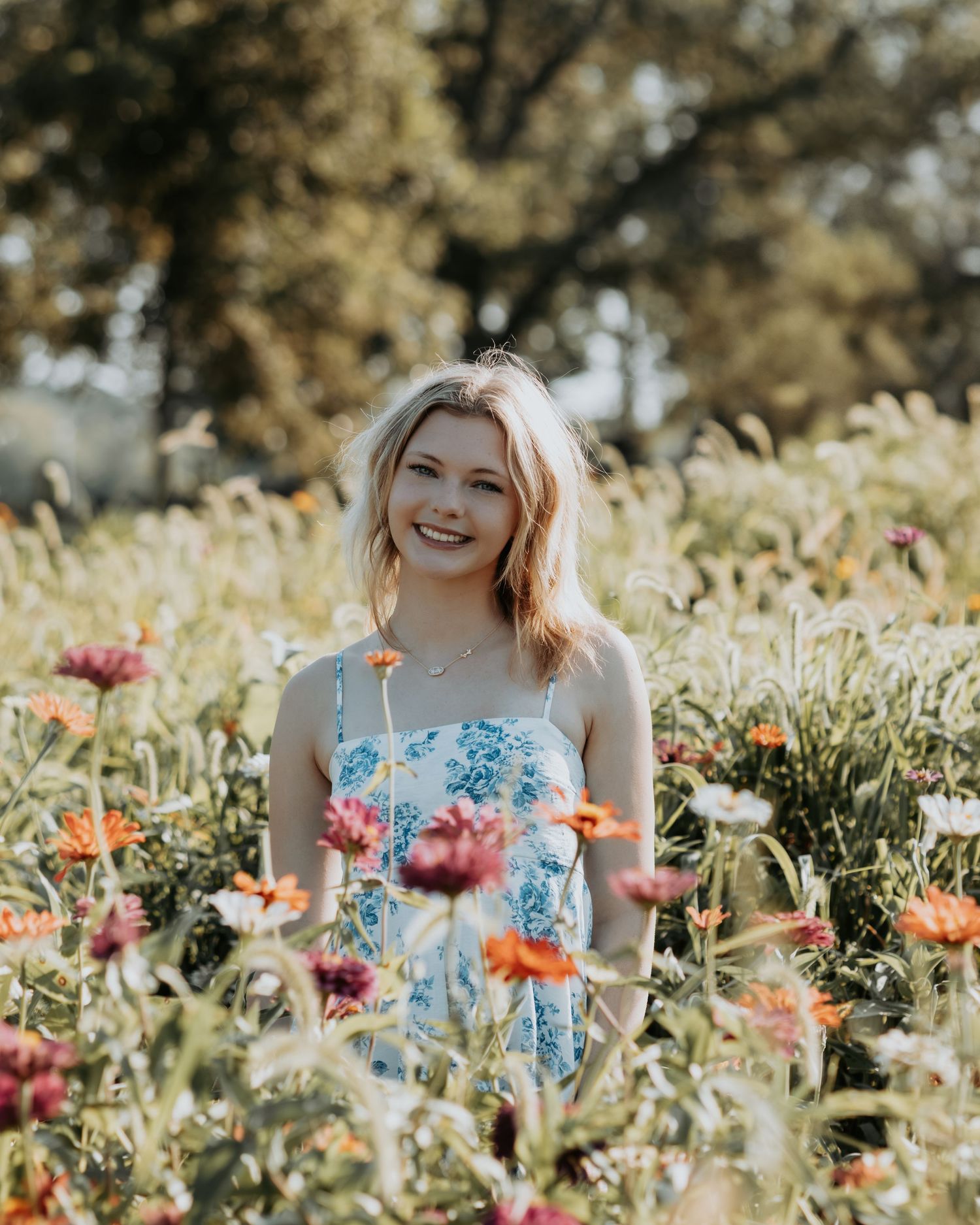 A vibrant field of colorful poppies and wildflowers glows in soft sunlight during a summer photo session.